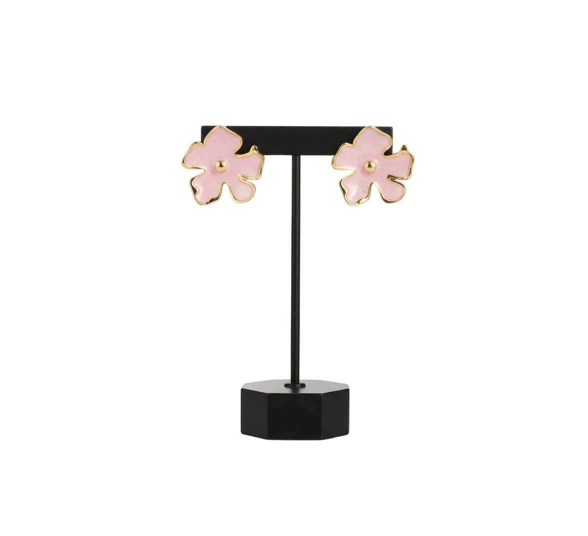 Pink flower-shaped earrings on a black stand with a white base against a white background