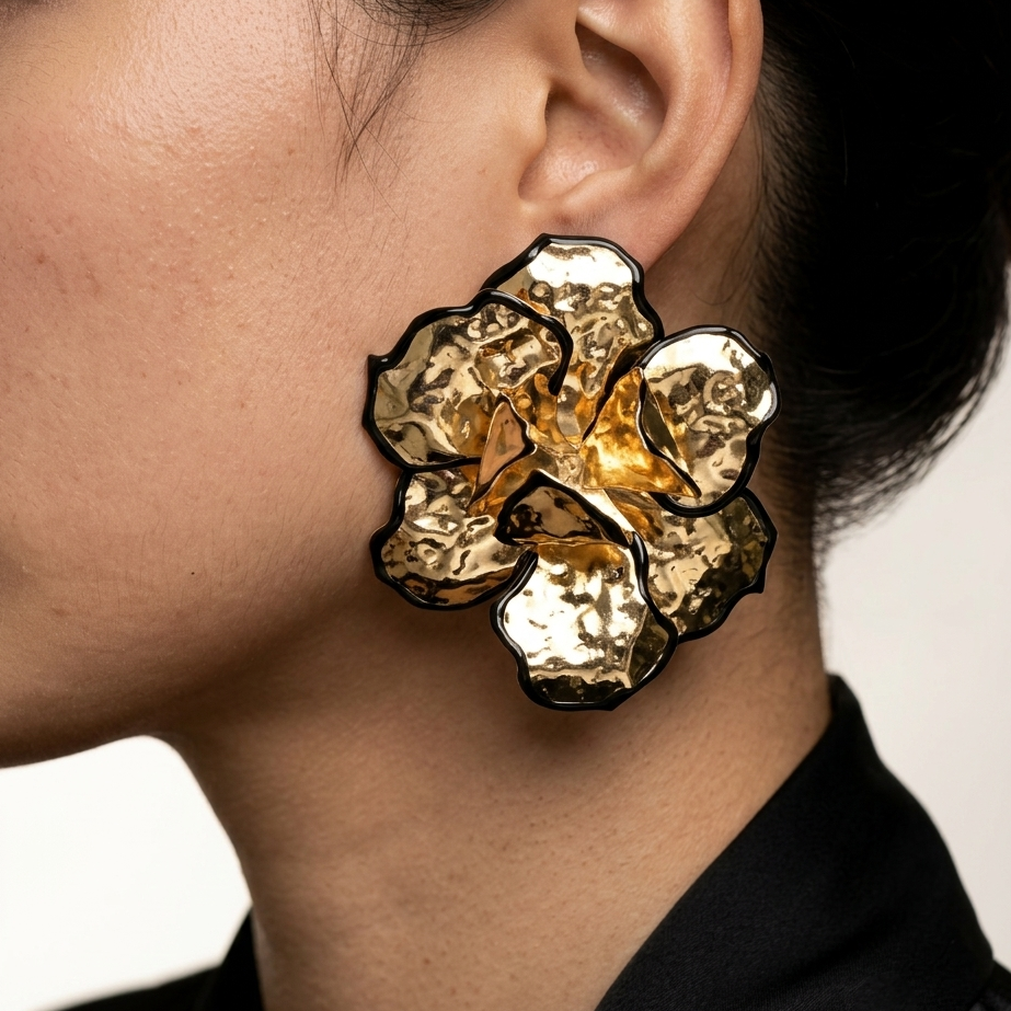 Model wearing Artistic oversized flower earrings featuring textured metal petals.