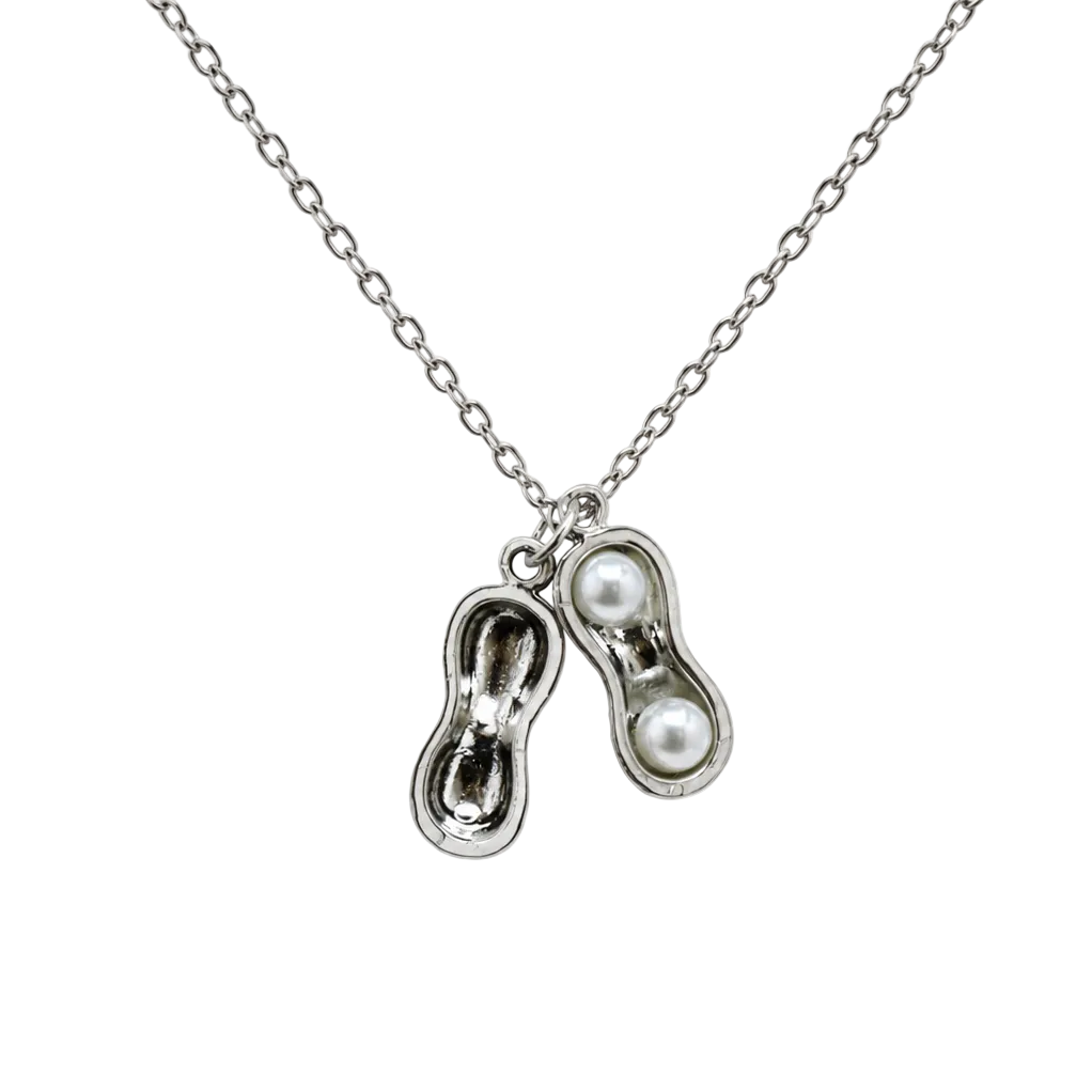Close-up view of the Peanut Pearl Locket opened to reveal two luminous pearls nestled within the textured metal