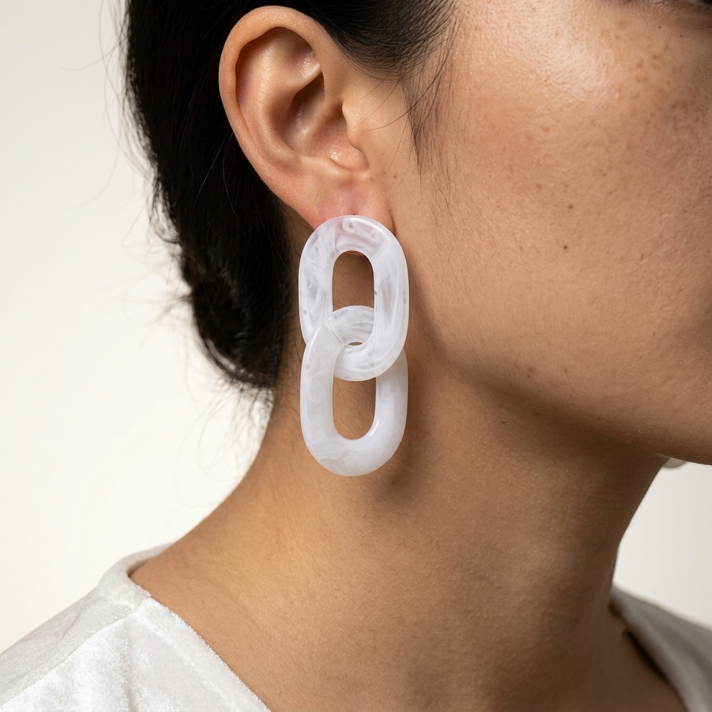Lightweight white marbled acrylic statement earrings featuring oversized linked oval shapes.
