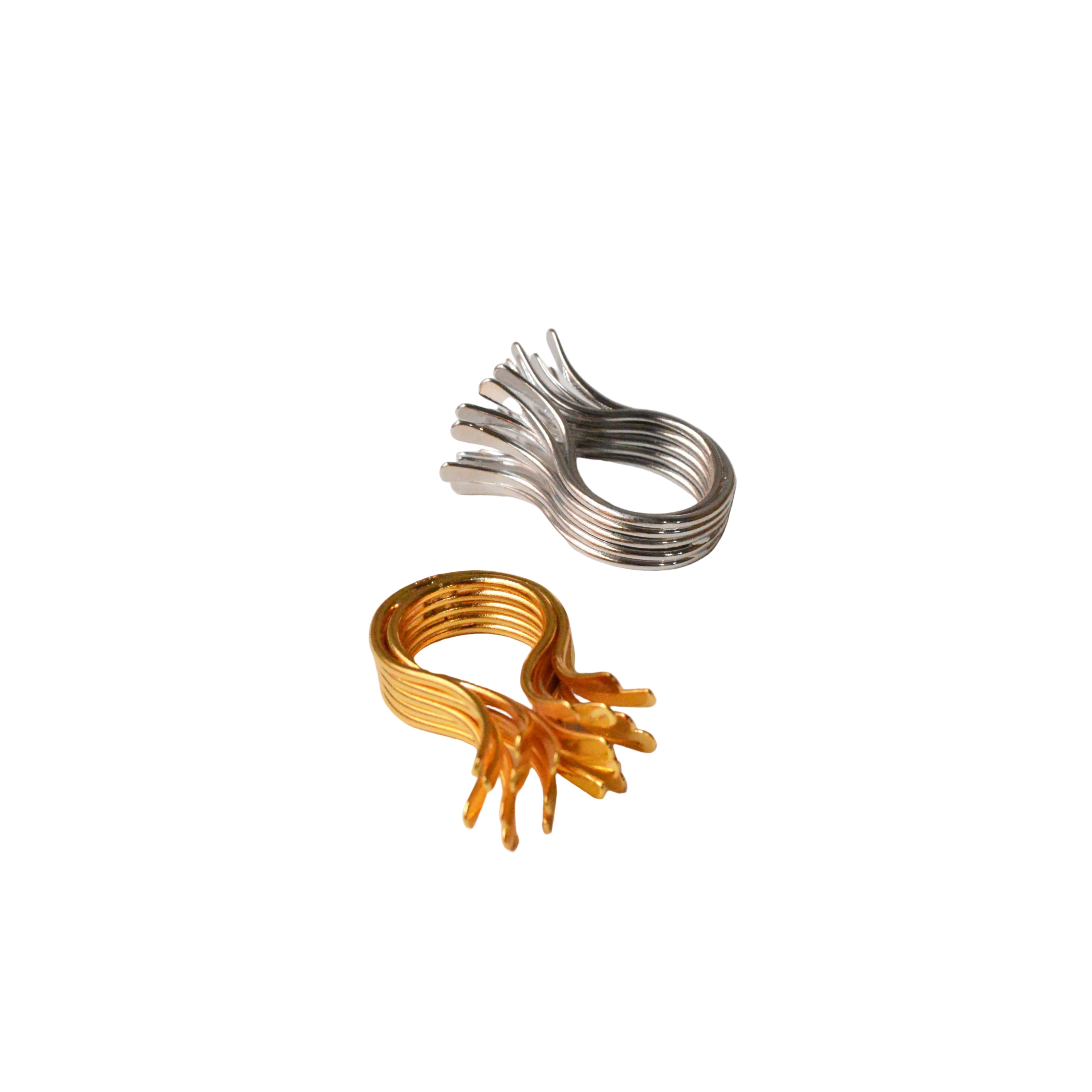 Set of gold and silver metal clips on a light gray background