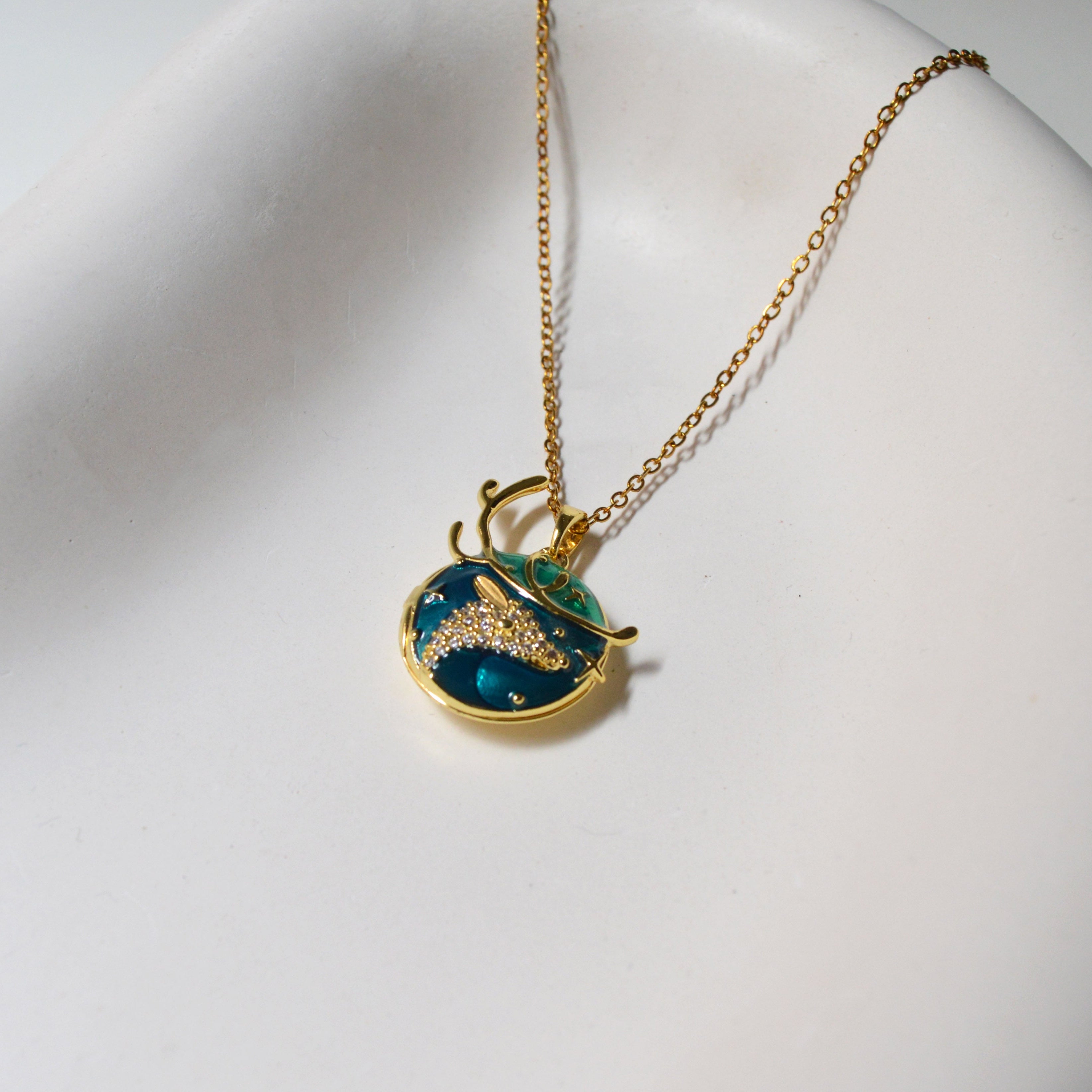 Side view of Celestial Fawn Pendant highlighting the depth of the metal framing and the dimensional fawn design