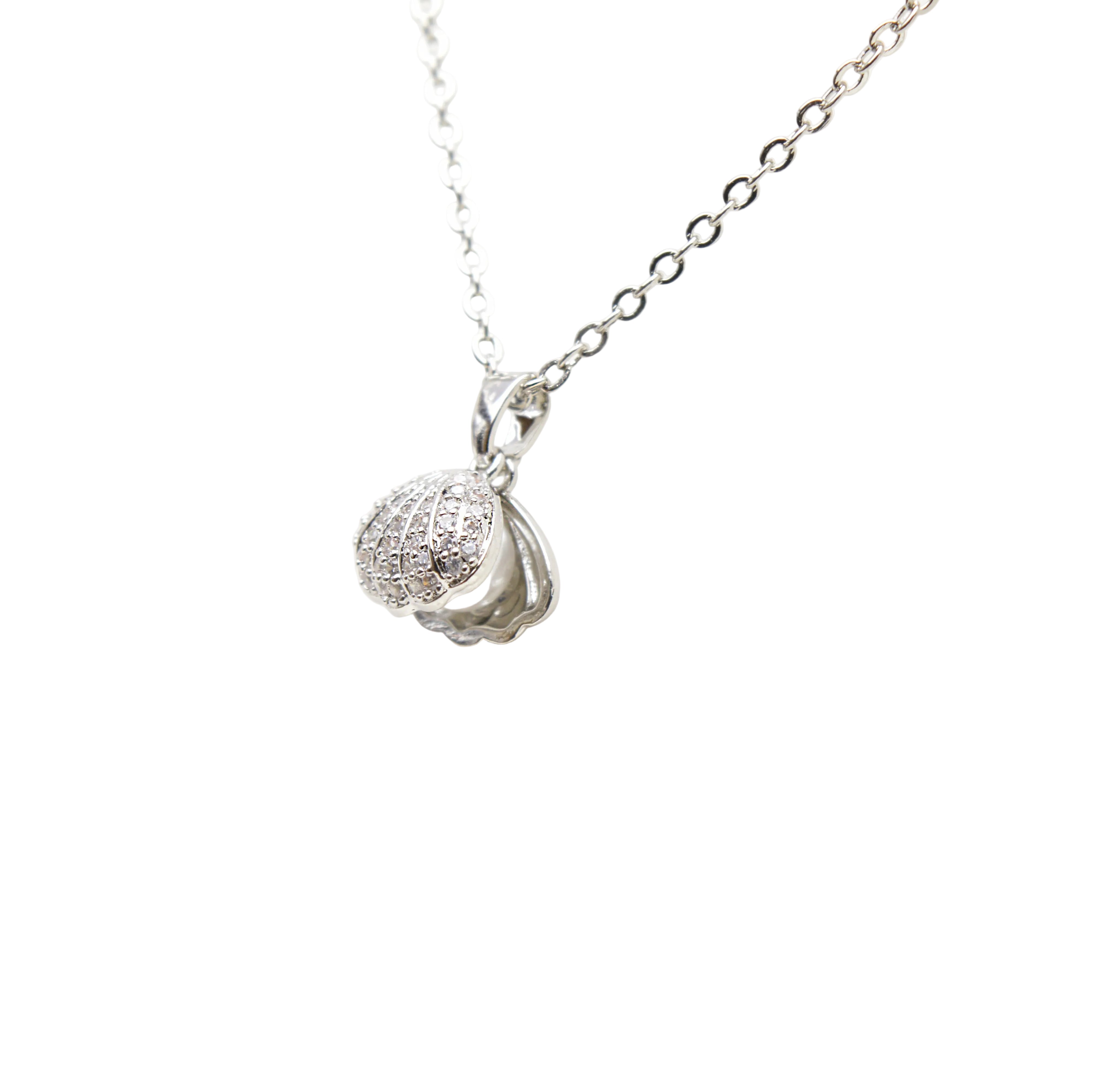 Close-up of pearl shell pendant necklace with shell-inspired design