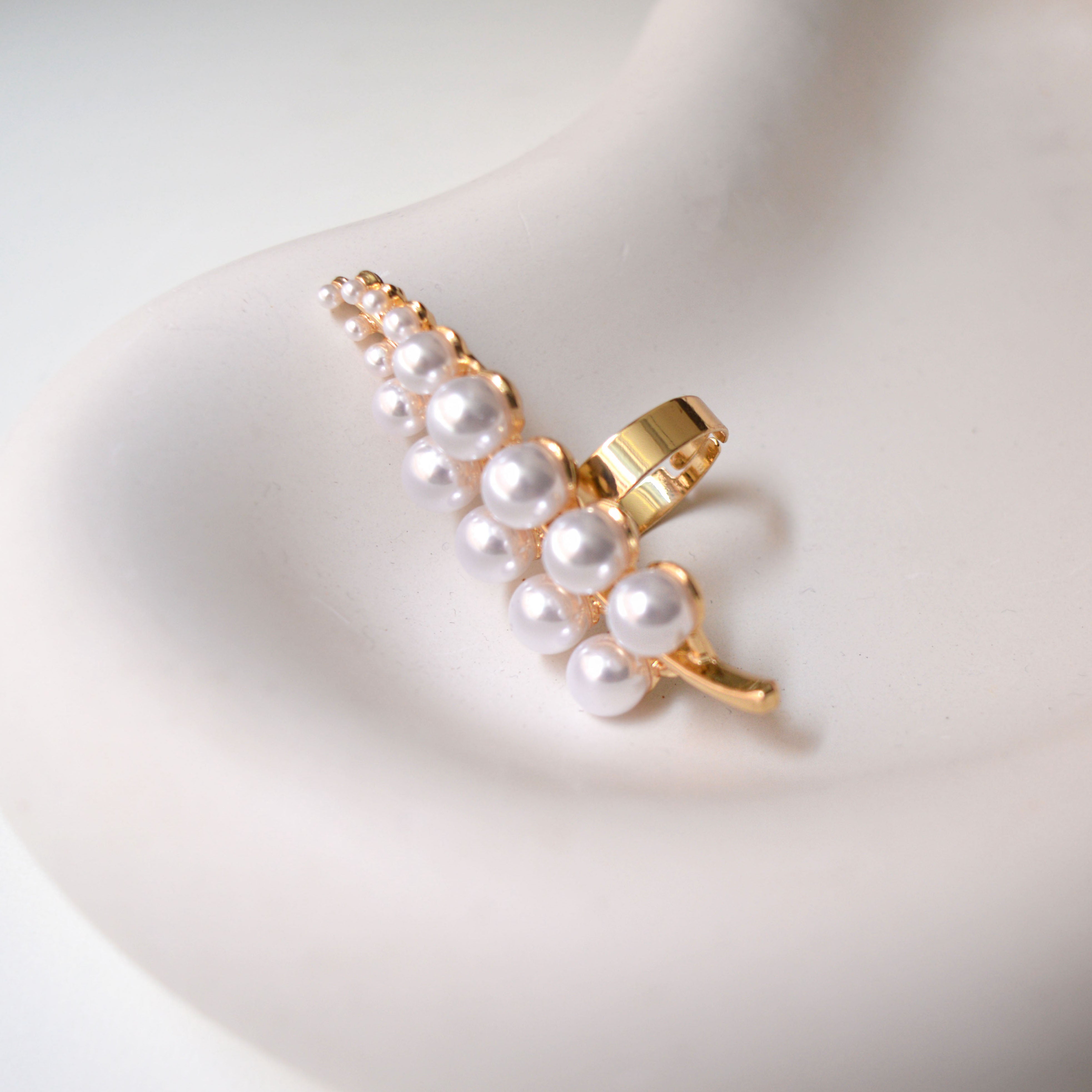     Gold adjustable pearl branch statement ring with botanical design.