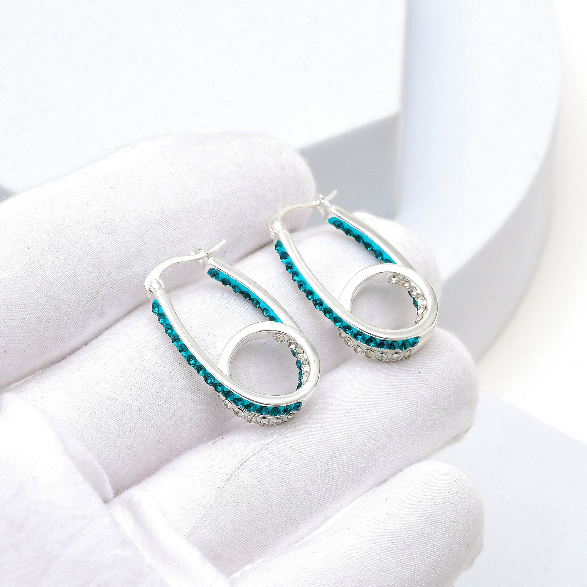 Video showcasing blue crystal double hoop earrings with sparkling crystal details