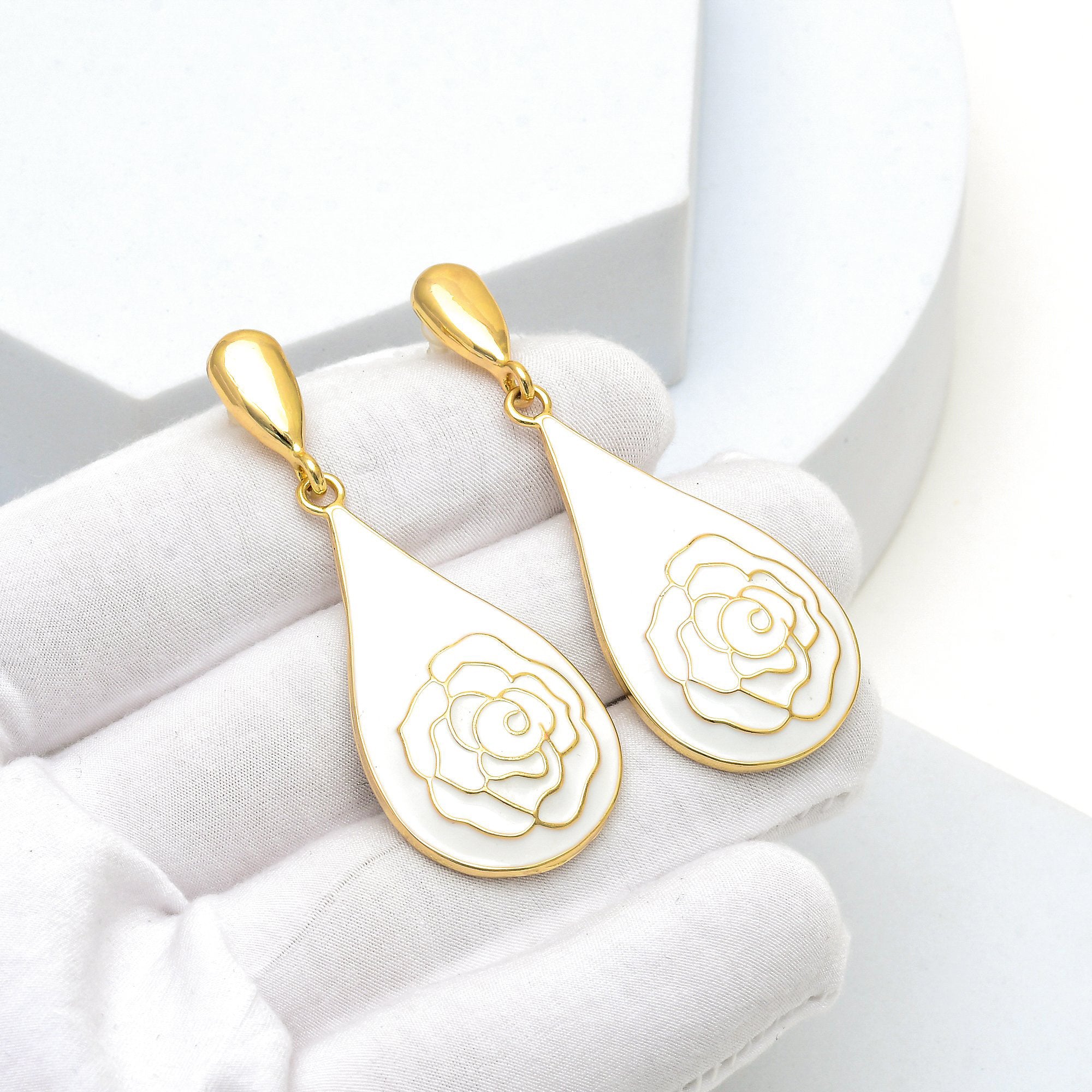 Close-up of the intricate gold rose detailing and smooth enamel finish of the Alabaster Rose teardrops