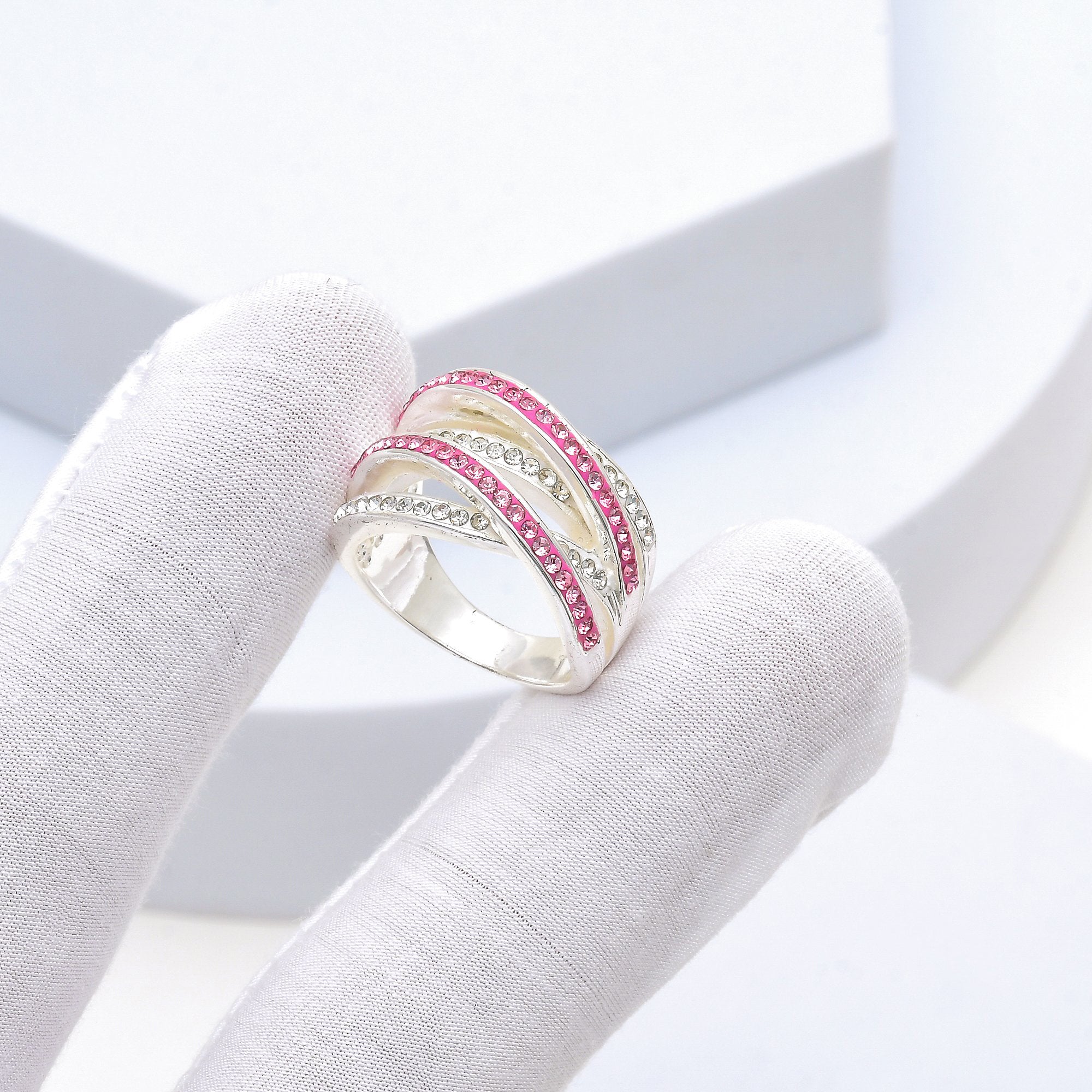 Video showcasing the intricate handcrafted details, fluid movement of the crisscross design, and high-shine brilliance of the Signature Pink Crossover ring