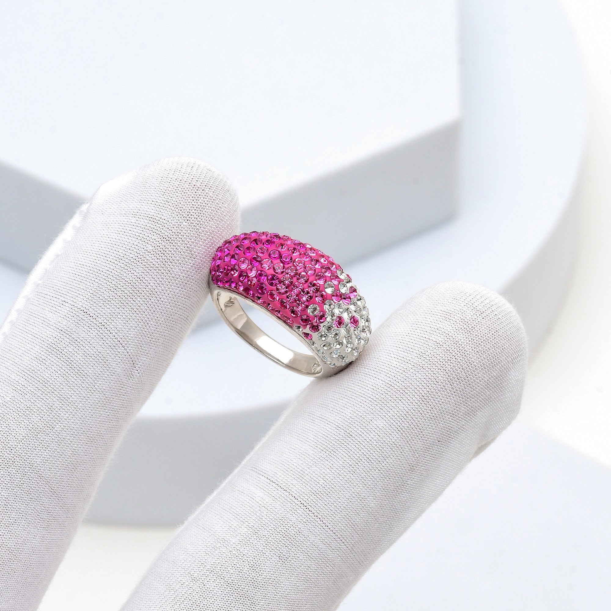 Close-up of the handcrafted dome surface and precision hand-set crystal ombré transition on the Signature Fuchsia ring
