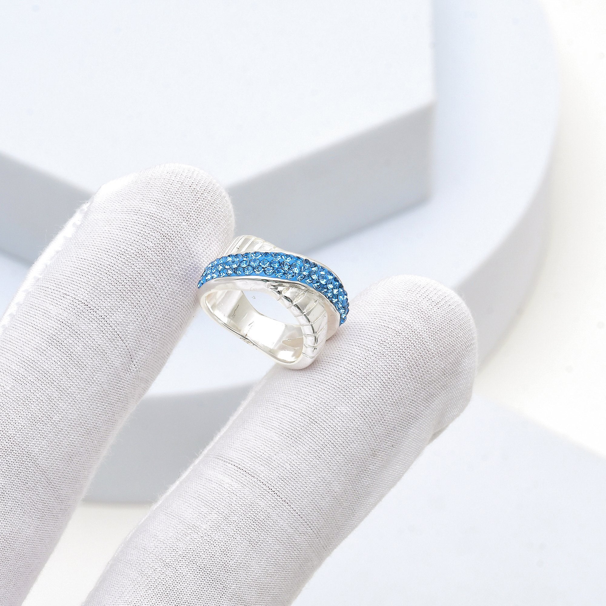 Close-up of the handcrafted crossover architecture and precision hand-set azure crystals on the Signature Azure band