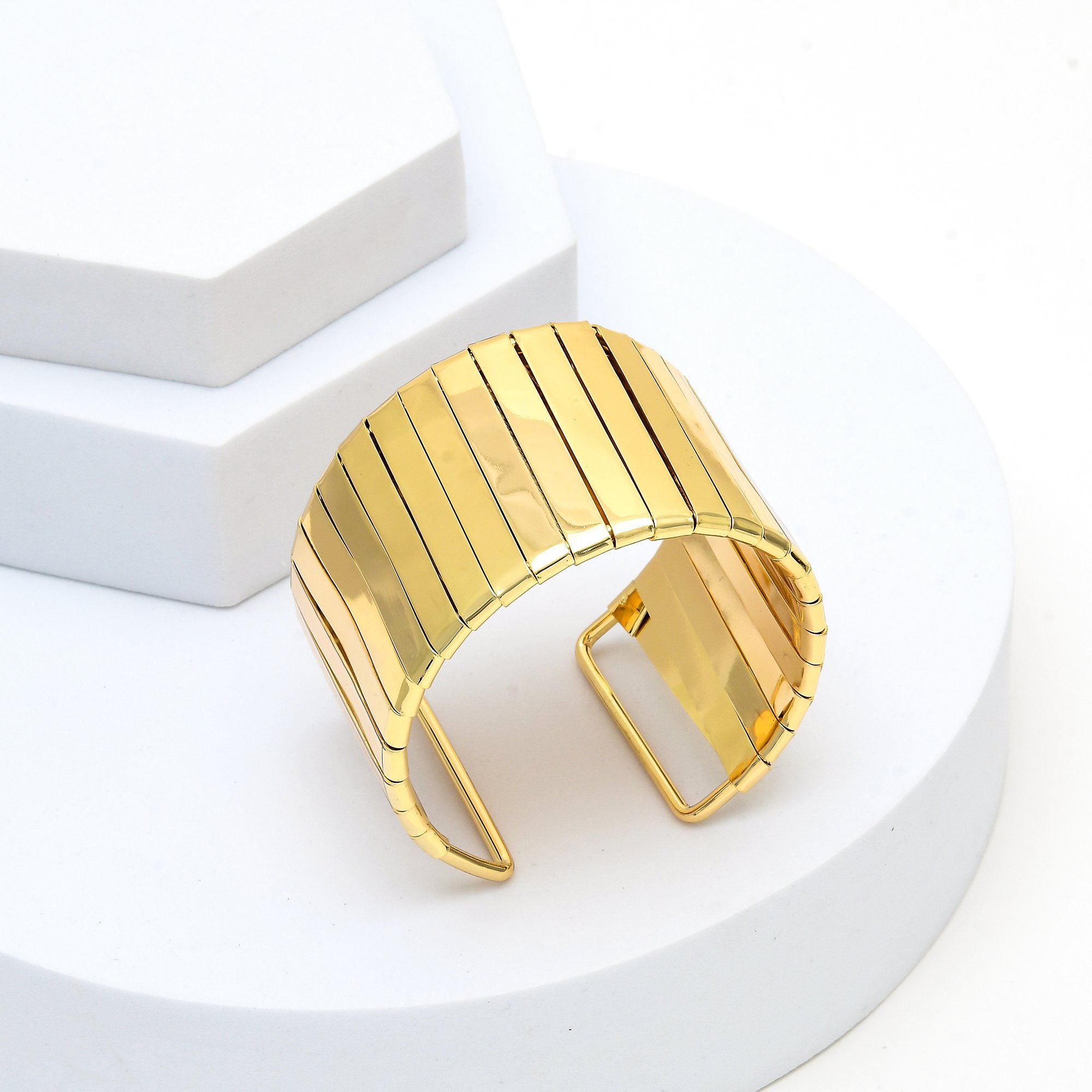 The anti tarnish gold toned Aurelia statement cuff bracelet showing its flexible vertical bar construction