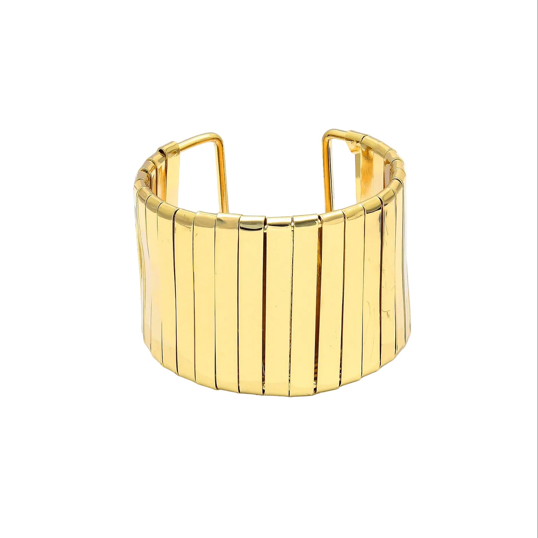 Aurelia segmented cuff bracelet in a polished gold toned finish displayed on a white hexagonal block