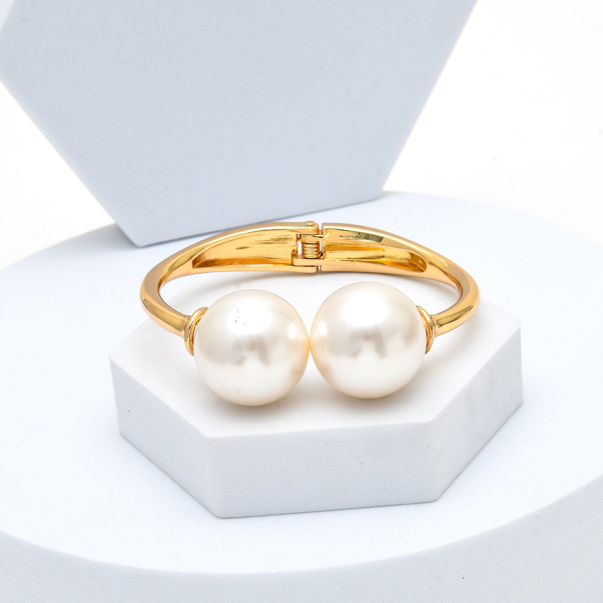 Close up of the secure bottom hinge clasp mechanism and smooth polished finish of the anti-tarnish Juno pearl bangle