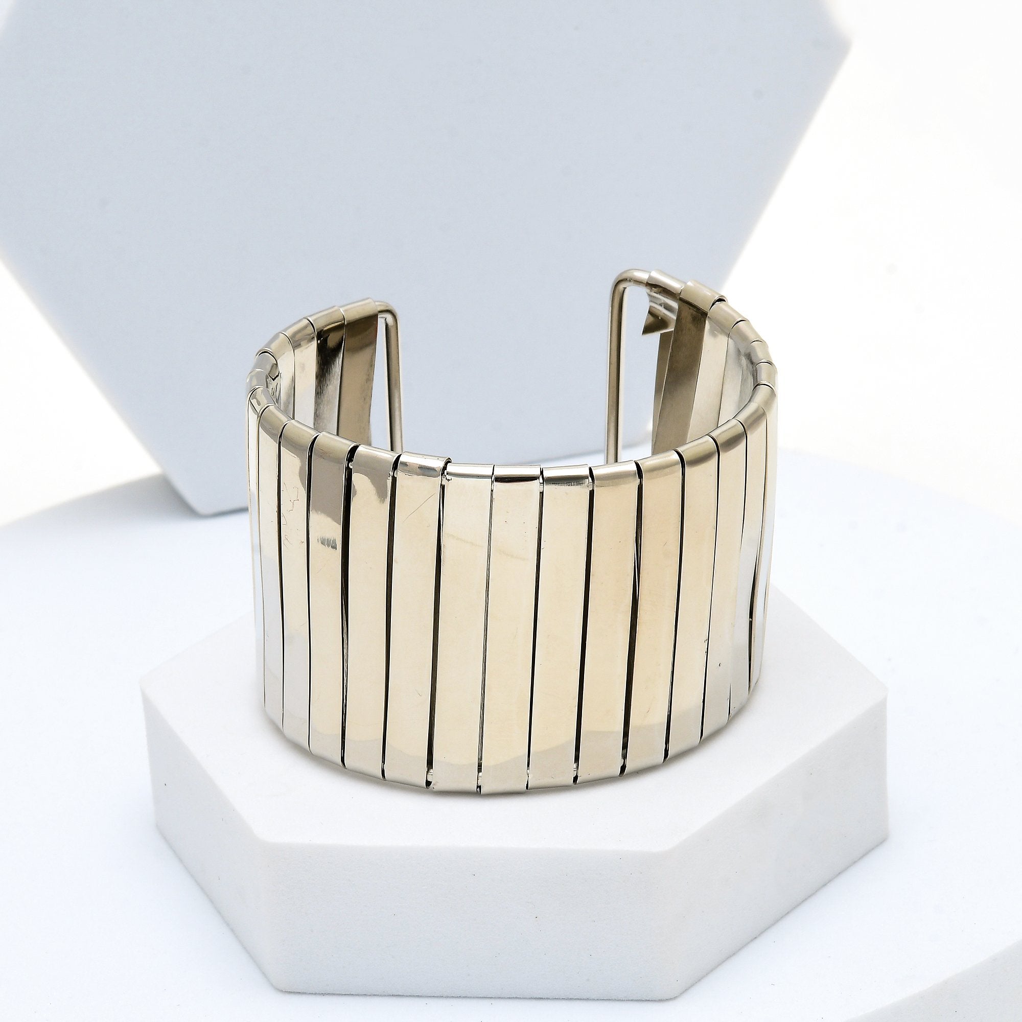 The anti tarnish gold and silver Aurelia statement cuff bracelets displayed side by side showing their flexible vertical bar construction