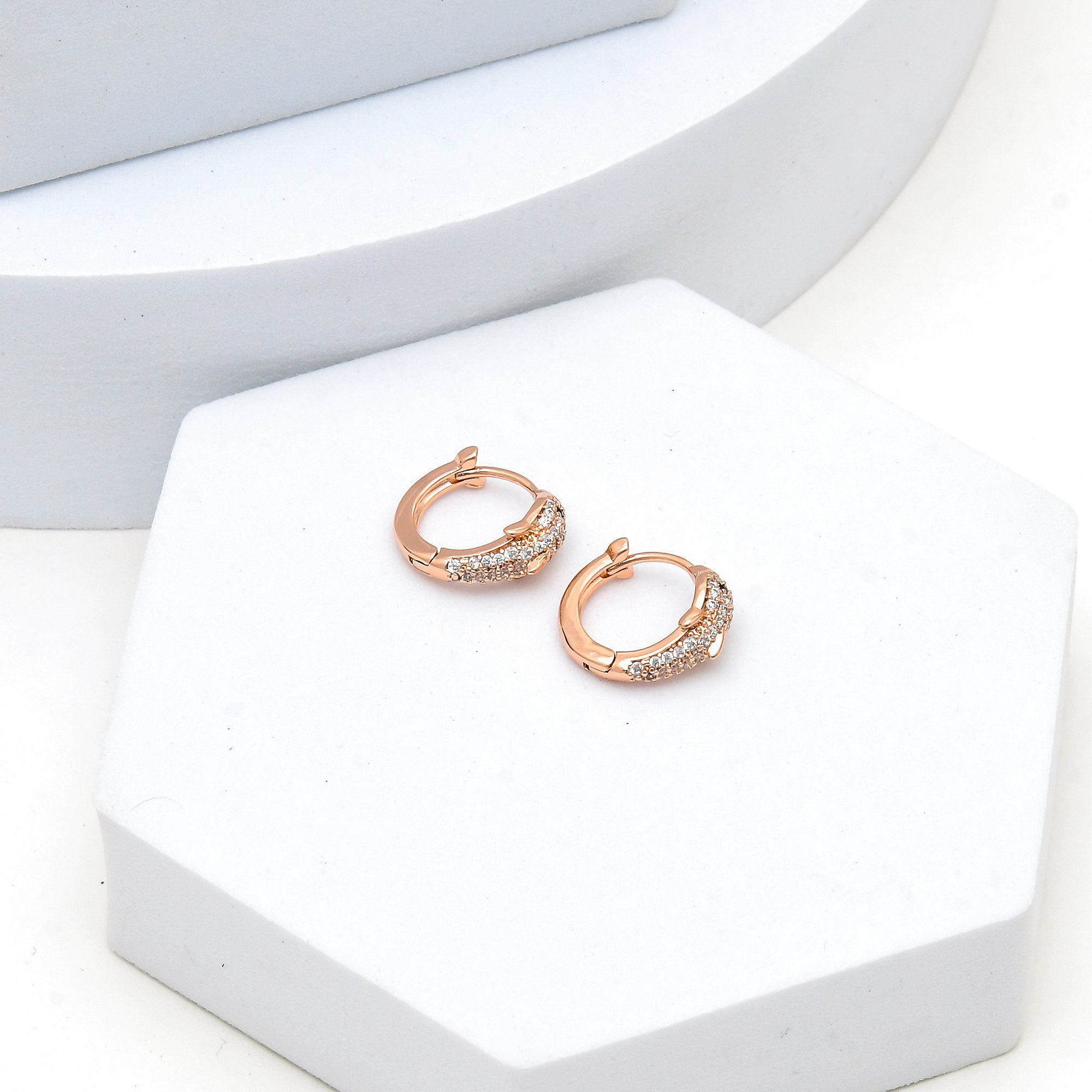 Close-up of anti-tarnish rose gold tone hoops designed for daily styling