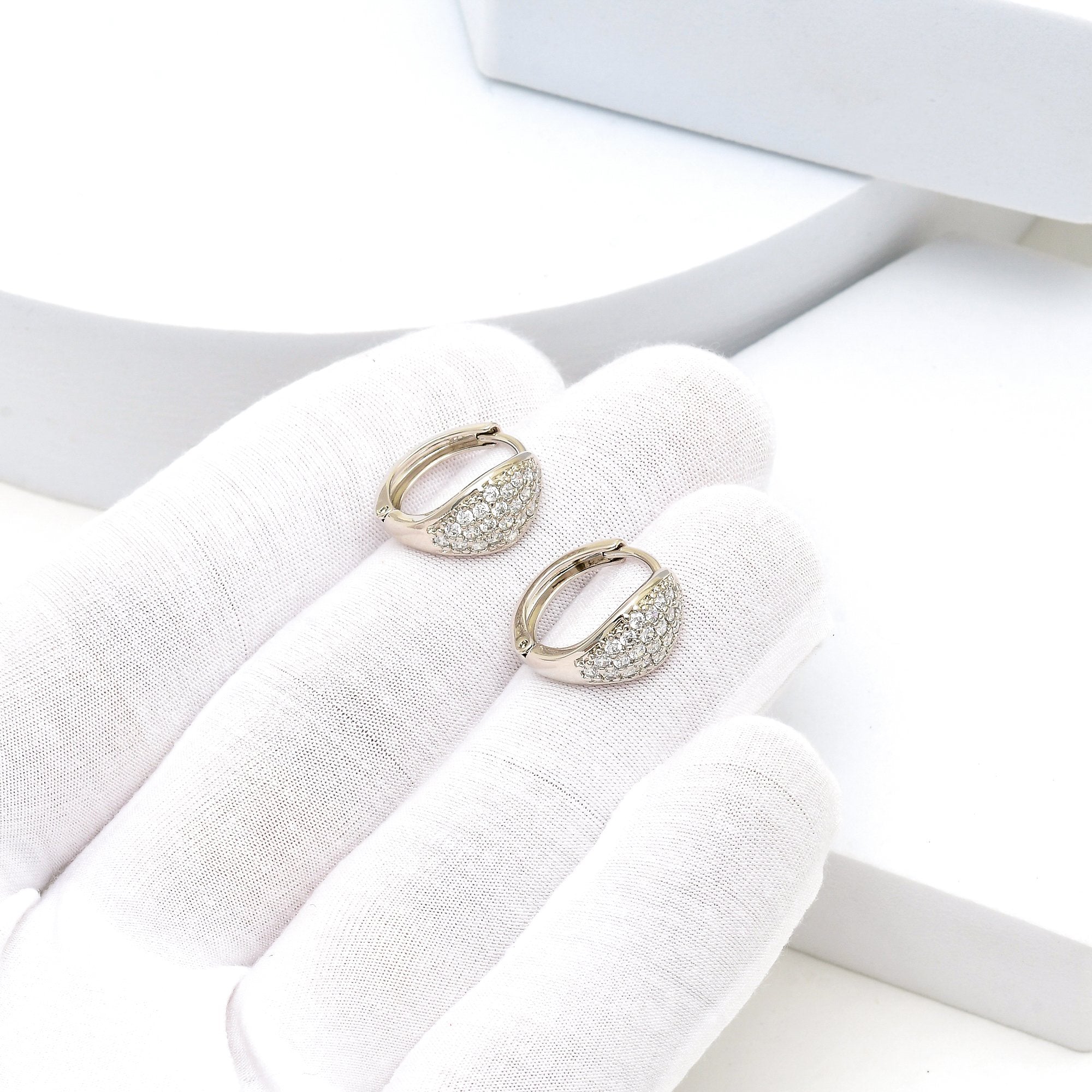     Close-up of minimal luxury mini hoops designed for daily styling