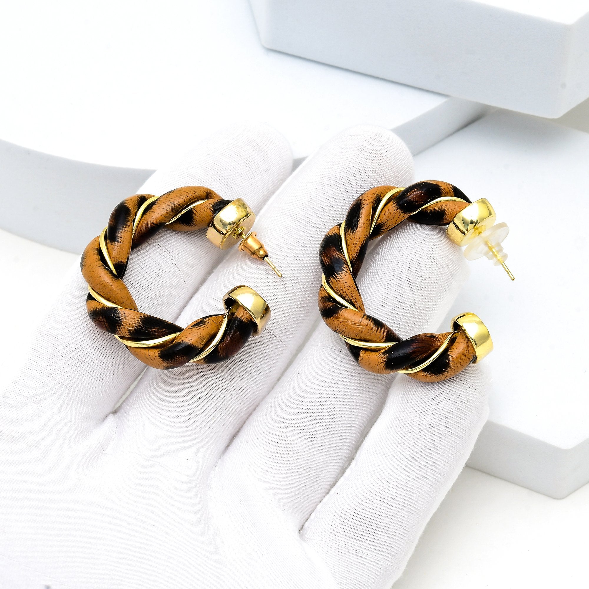     Modern luxury hoop earrings with fluid twisted silhouette