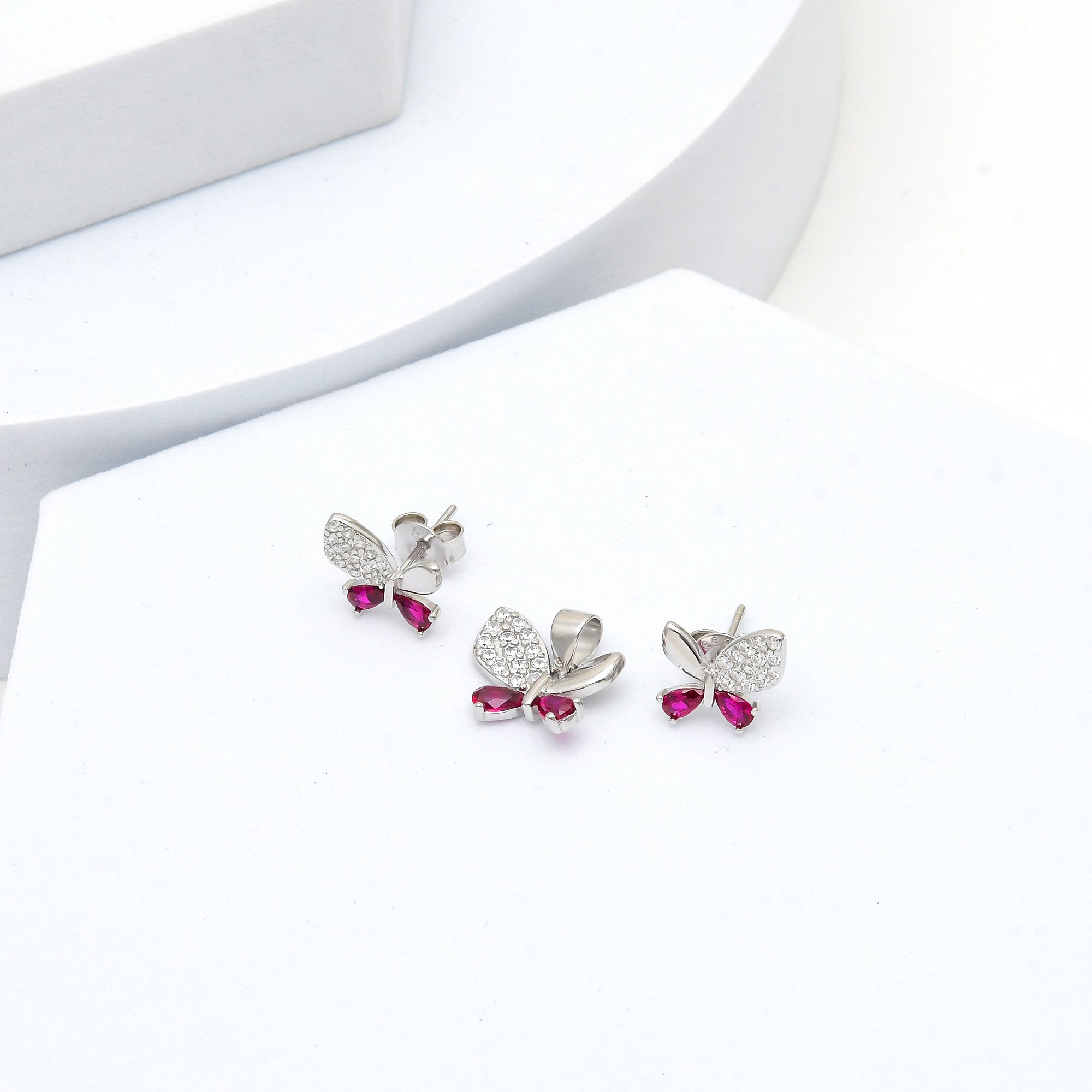 Close-up of sterling silver butterfly pendant with sparkling white and pink stones