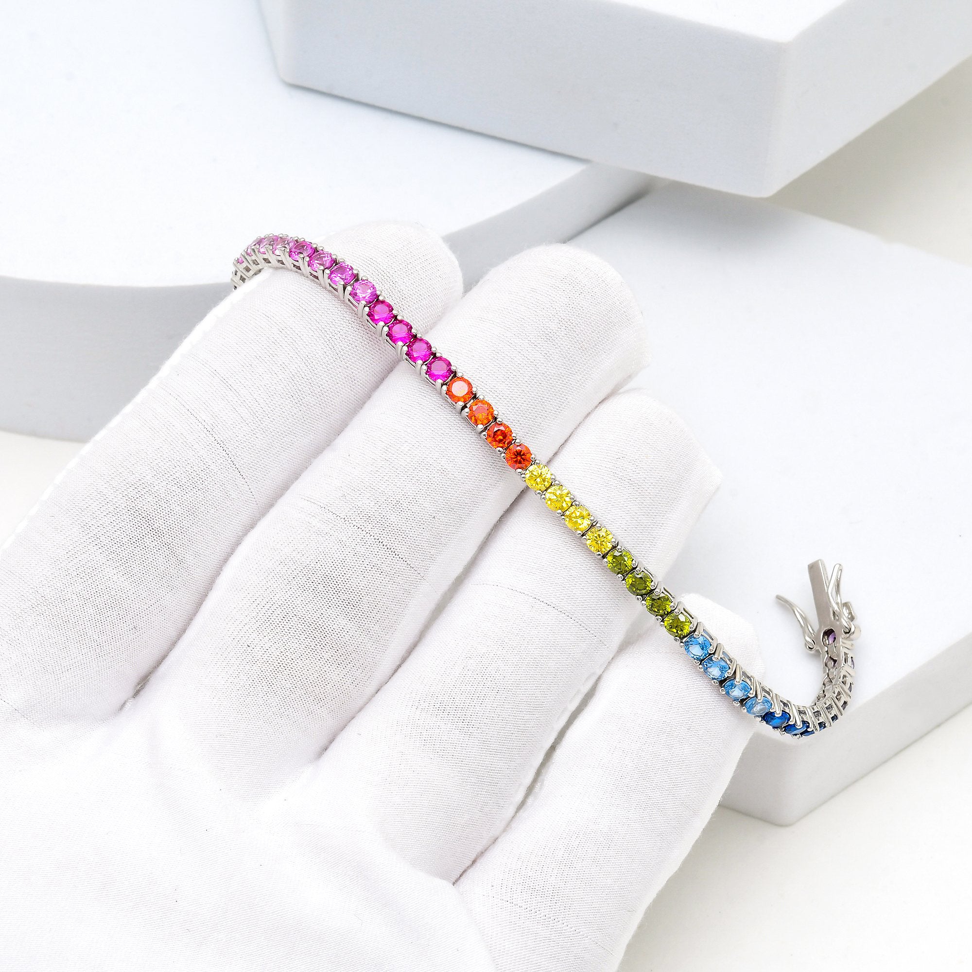     Close-up of multi-colour sterling silver bracelet reflecting light in motion