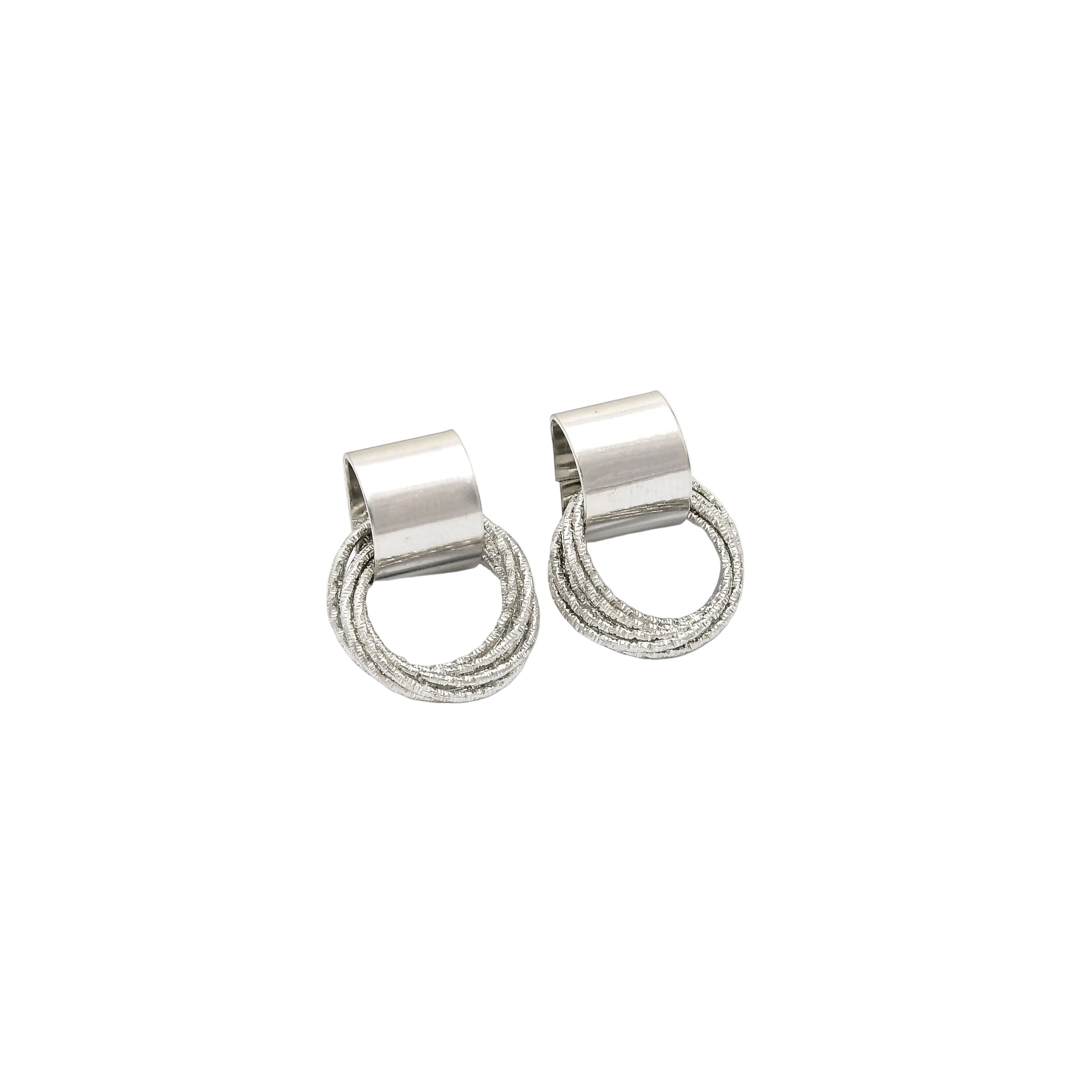 A pair of silver-toned hoop earrings with a textured, twisted lower half and a smooth rectangular post, displayed on a white geometric background by CIVARO