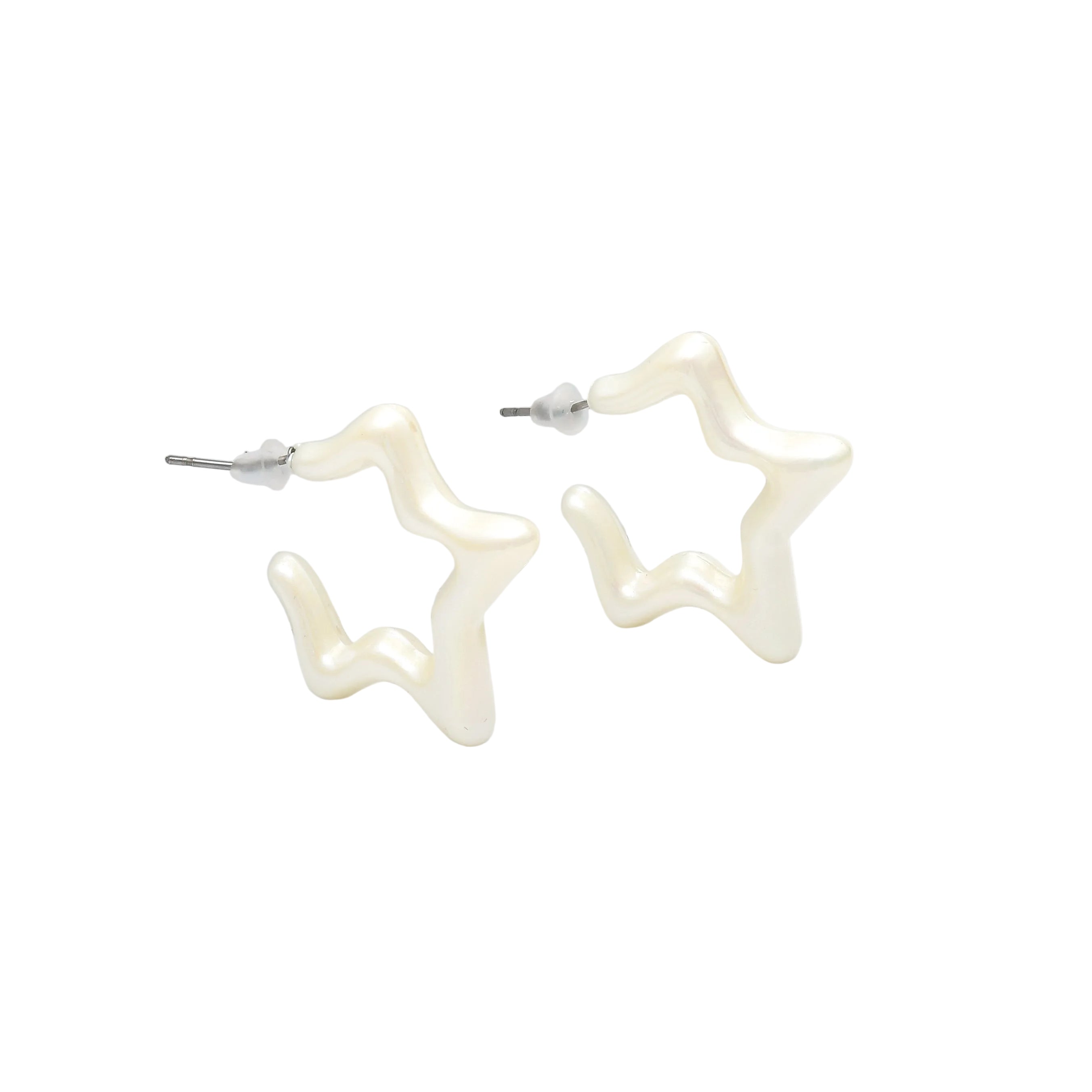 A pair of open star-shaped hoop earrings with a glossy, cream-colored finish and silver posts, displayed on a white geometric riser.