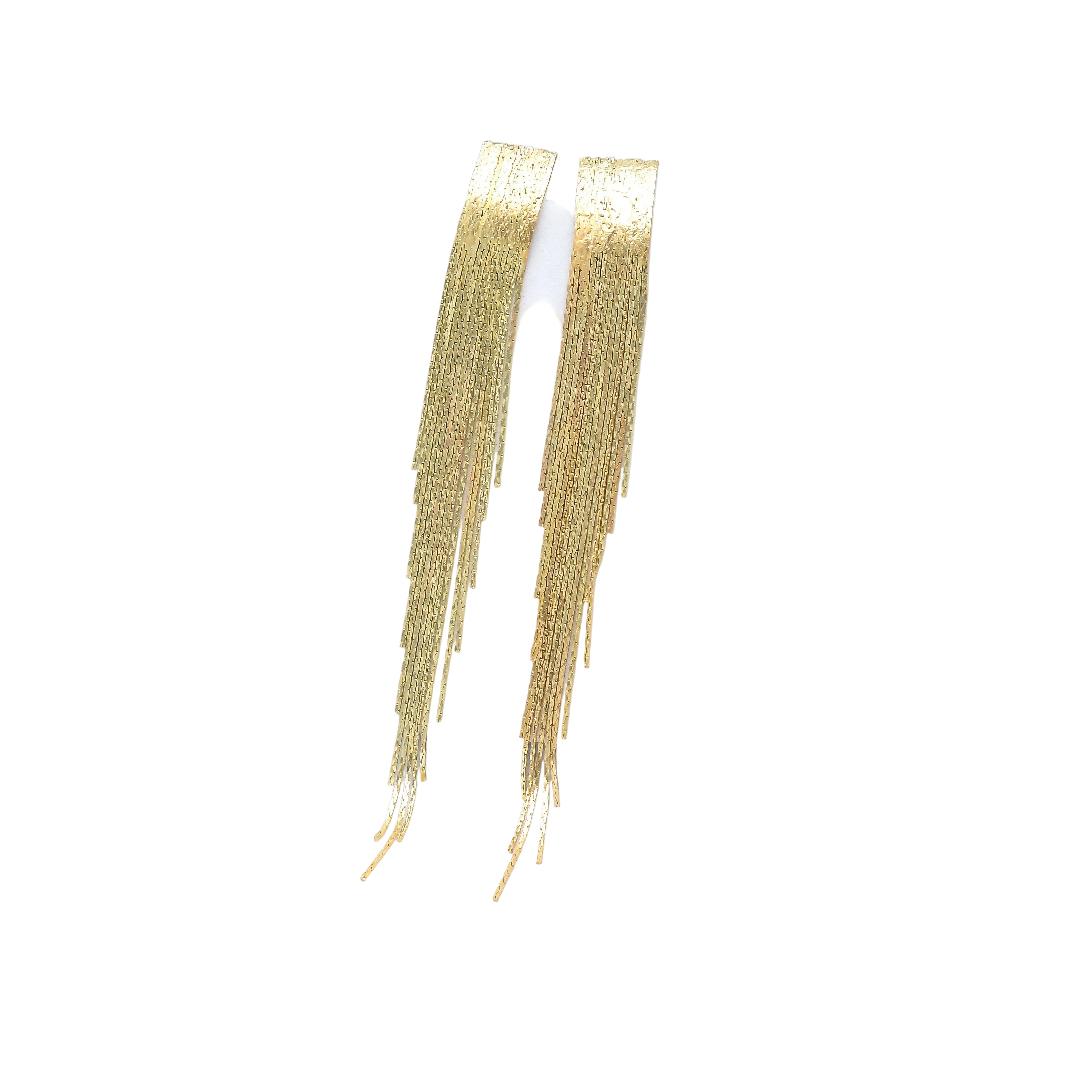A pair of gold-toned fringe earrings displayed on a white hexagonal jewelry stand against a clean white background by Civaro
