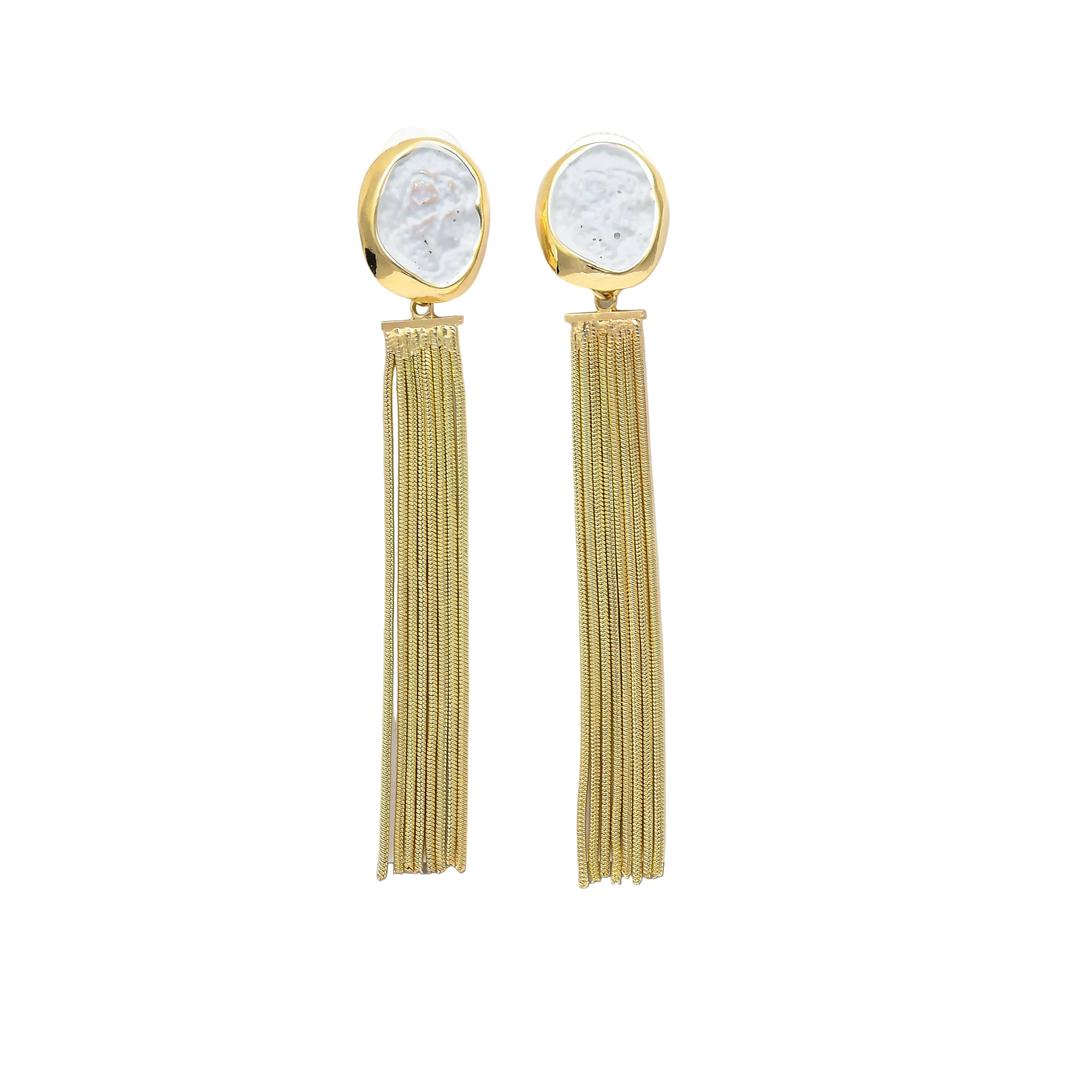 A pair of gold-tone dangle earrings with textured white stone tops and long thin gold fringe, displayed on a white geometric stand against a white background by Civaro