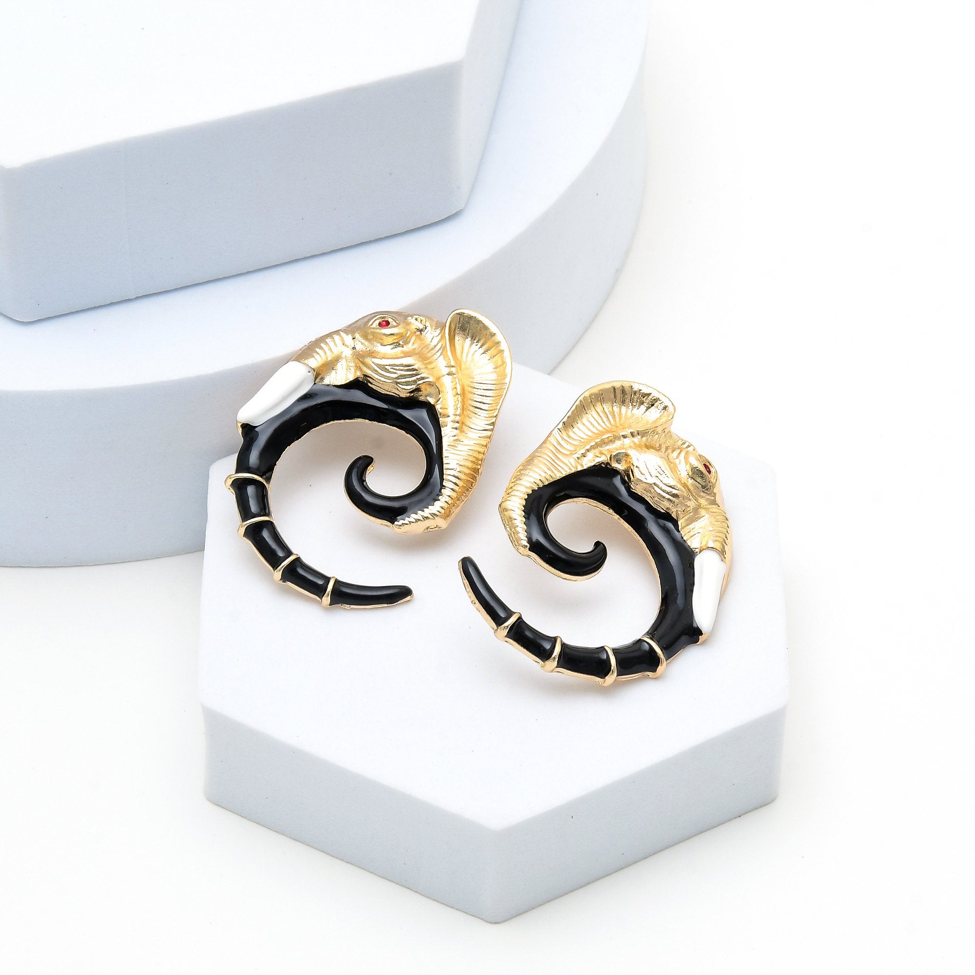 Sculptural gold elephant earrings featuring black enamel detailing by civaro