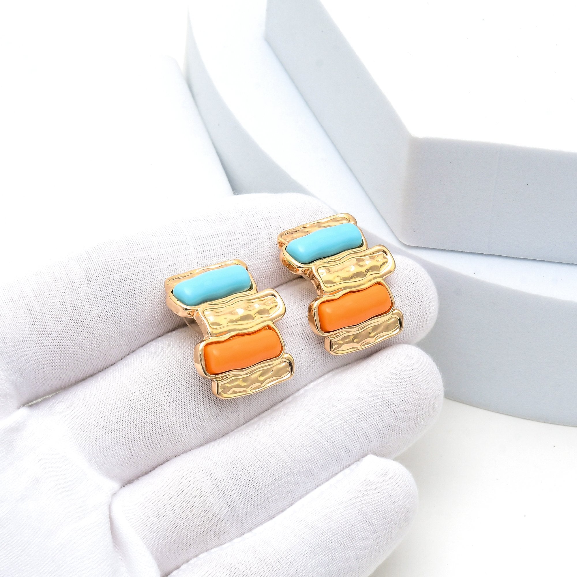 Lightweight everyday stud earrings with turquoise blue and orange accents.