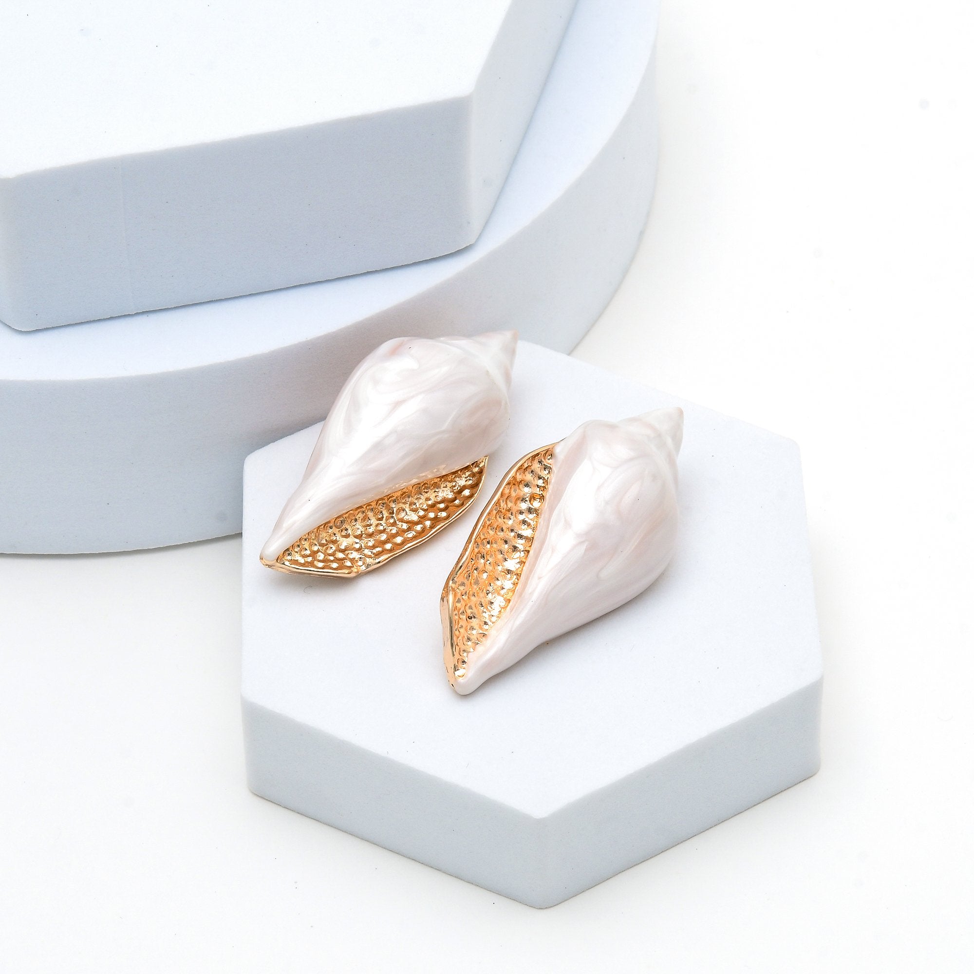 Elegant ivory shell stud earrings with gold textured interior inspired by ocean shells and handcrafted for modern everyday luxury.