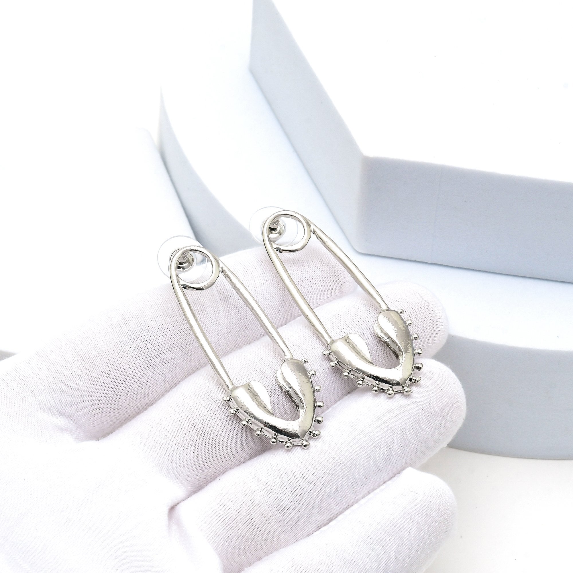     Lightweight polished silver drop earrings for everyday and occasion styling.