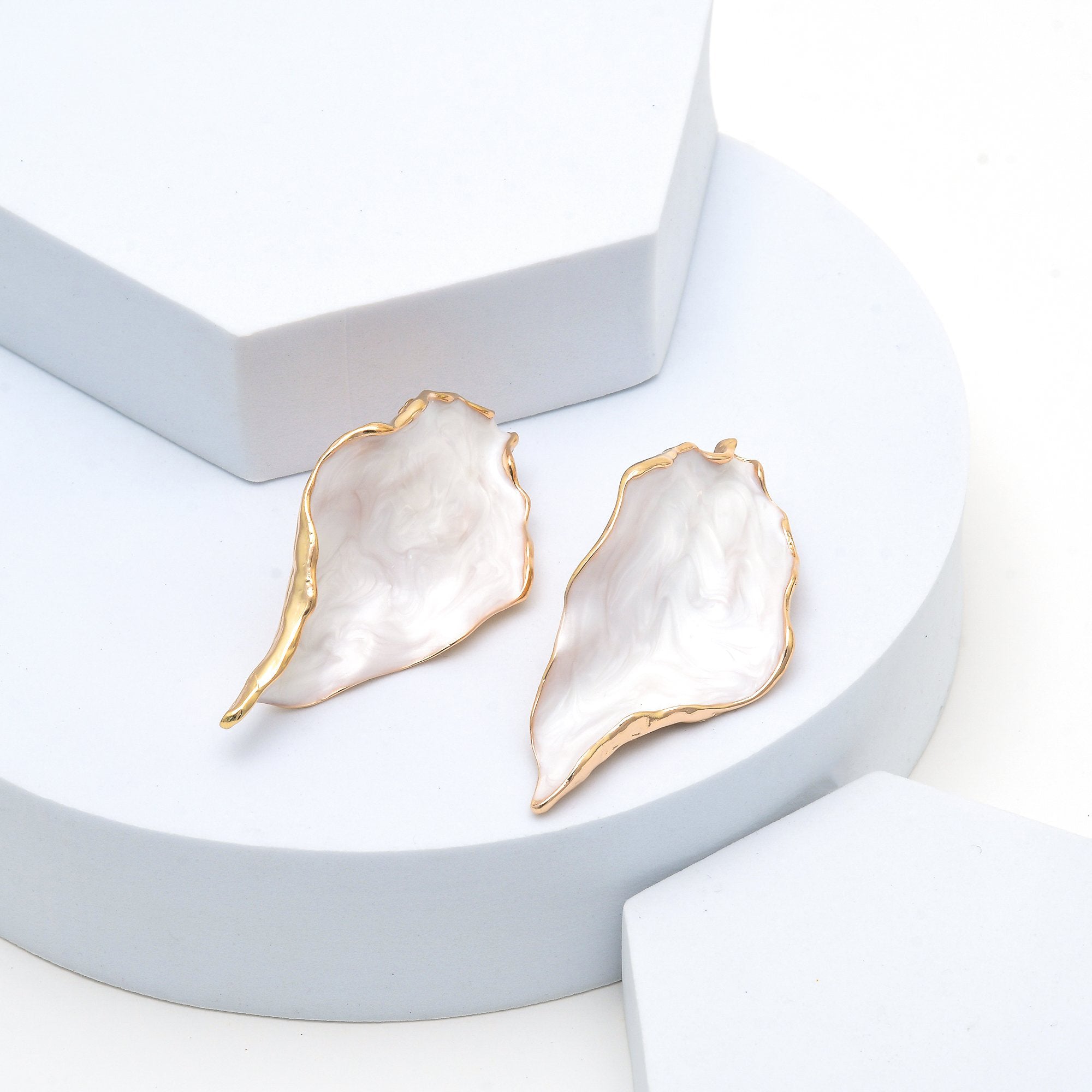    Modern marbled acrylic statement earrings featuring layered construction and contemporary design.