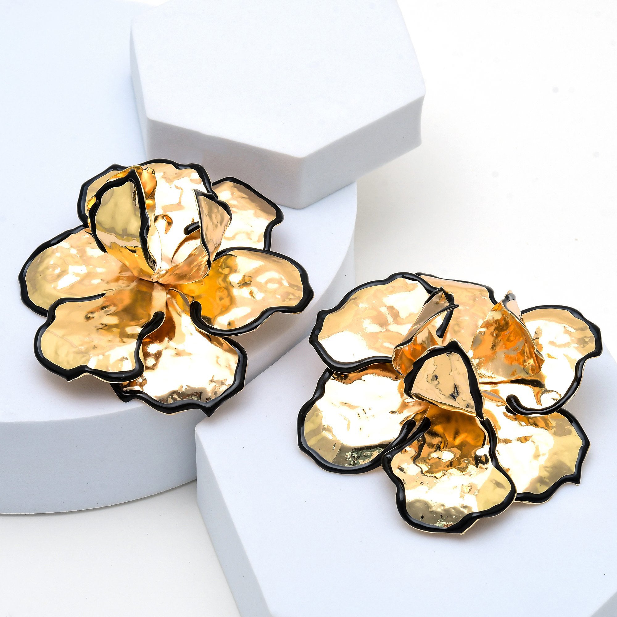 Bold handcrafted metal flower earrings for contemporary statement styling.