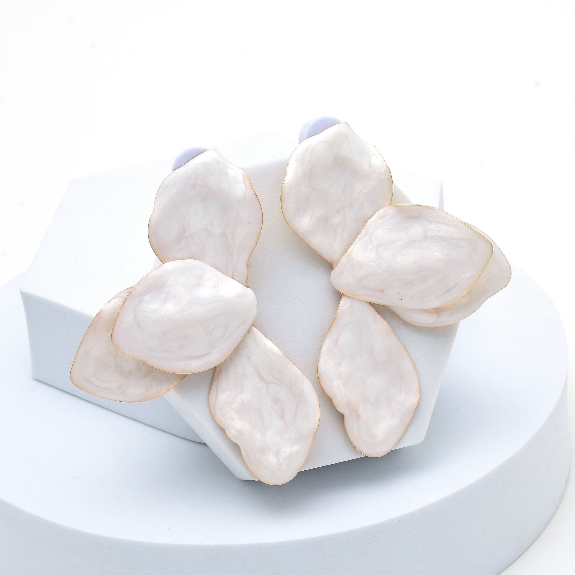 Contemporary layered petal statement earrings crafted from alloy and brass.
