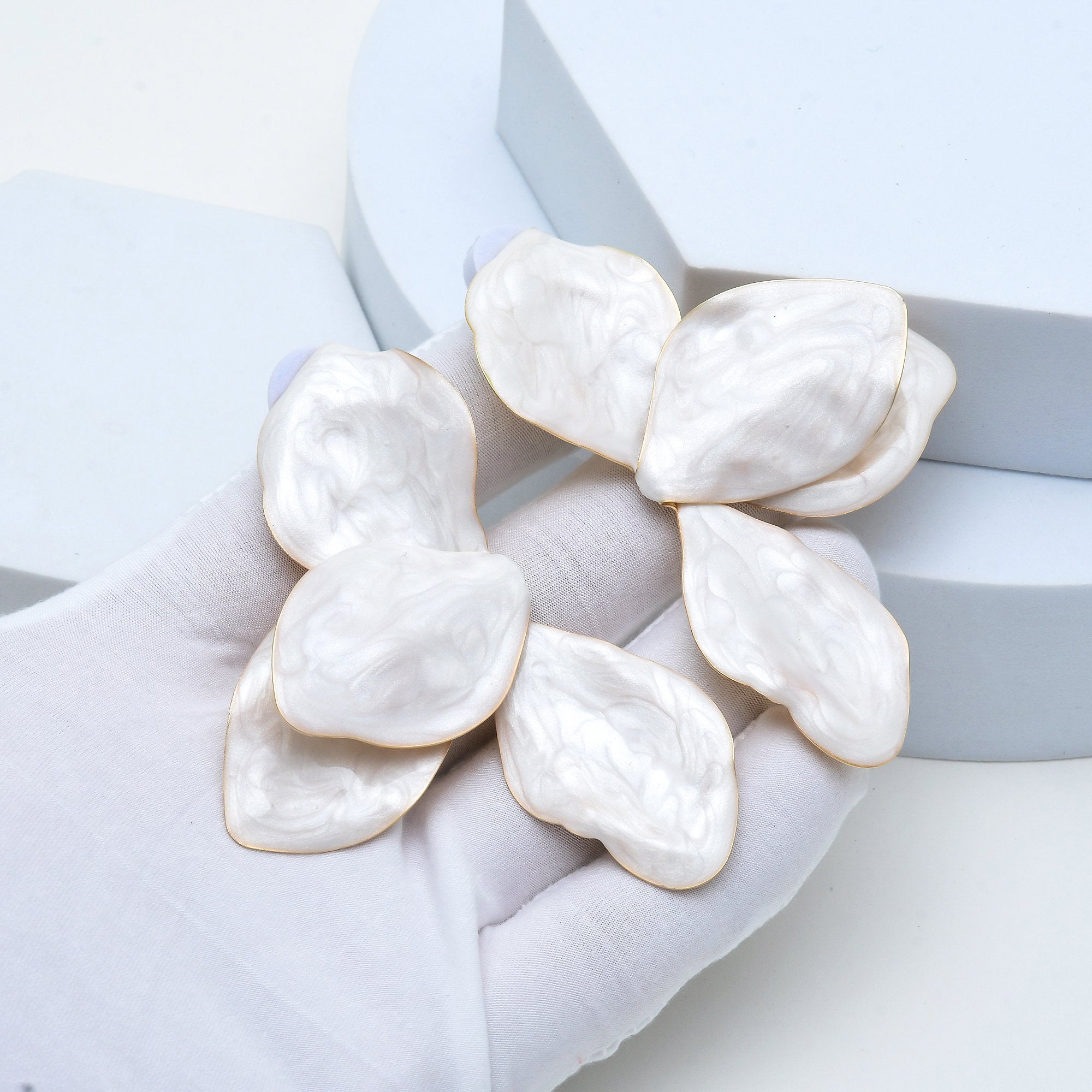 Luxury-inspired oversized flower earrings with luminous enamel detailing.