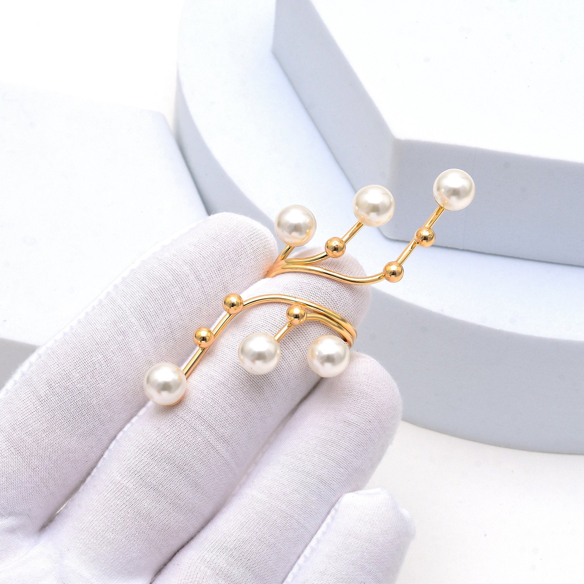 Elegant gold plated pearl ring with vine inspired design
