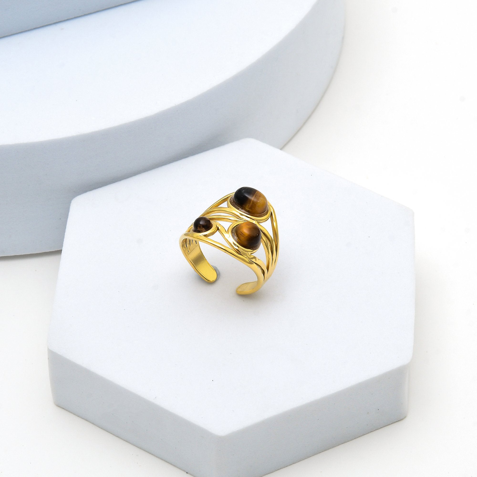     Gold sculptural ring with polished natural tiger eye gemstones.