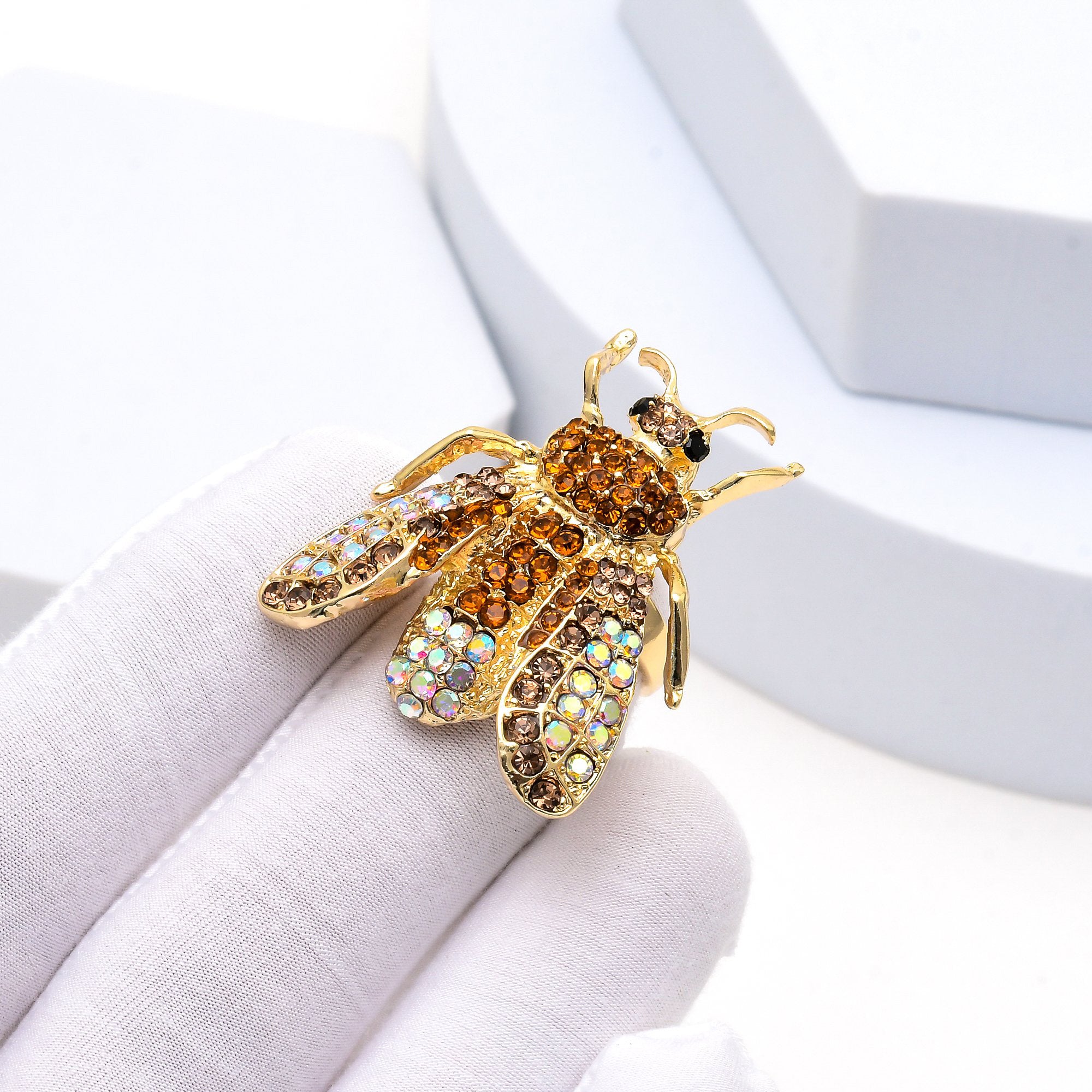     Gold rhinestone insect ring with intricate bee detailing.
