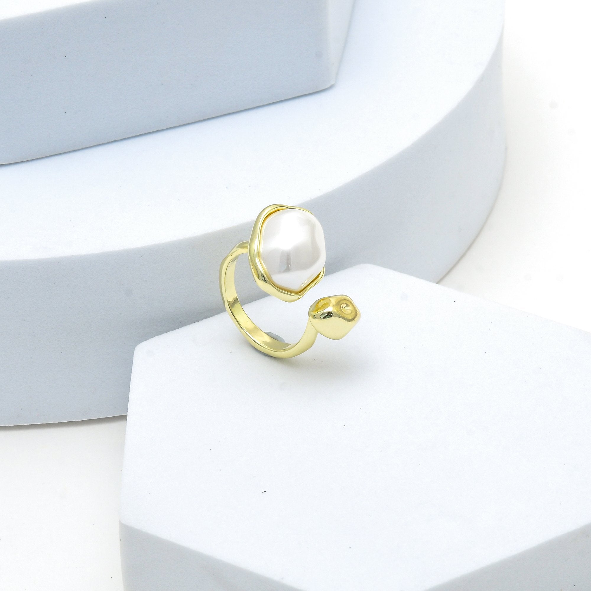     Contemporary gold statement ring featuring a baroque-inspired pearl.