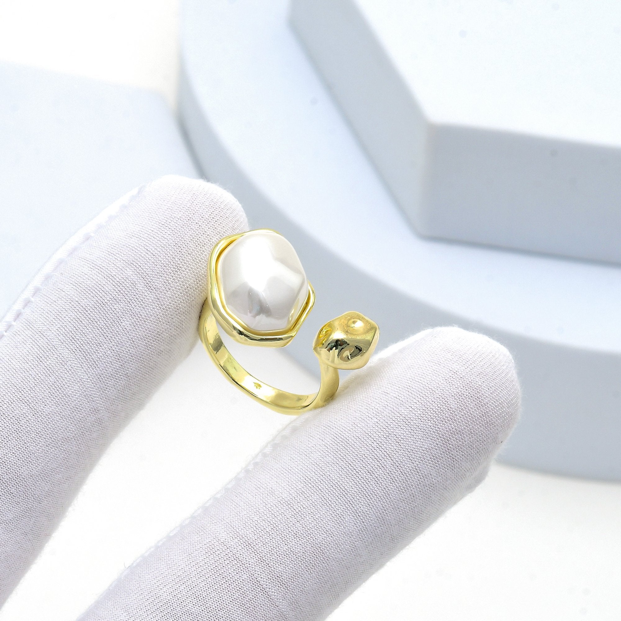    Handcrafted adjustable ring with organic pearl and molten gold finish.