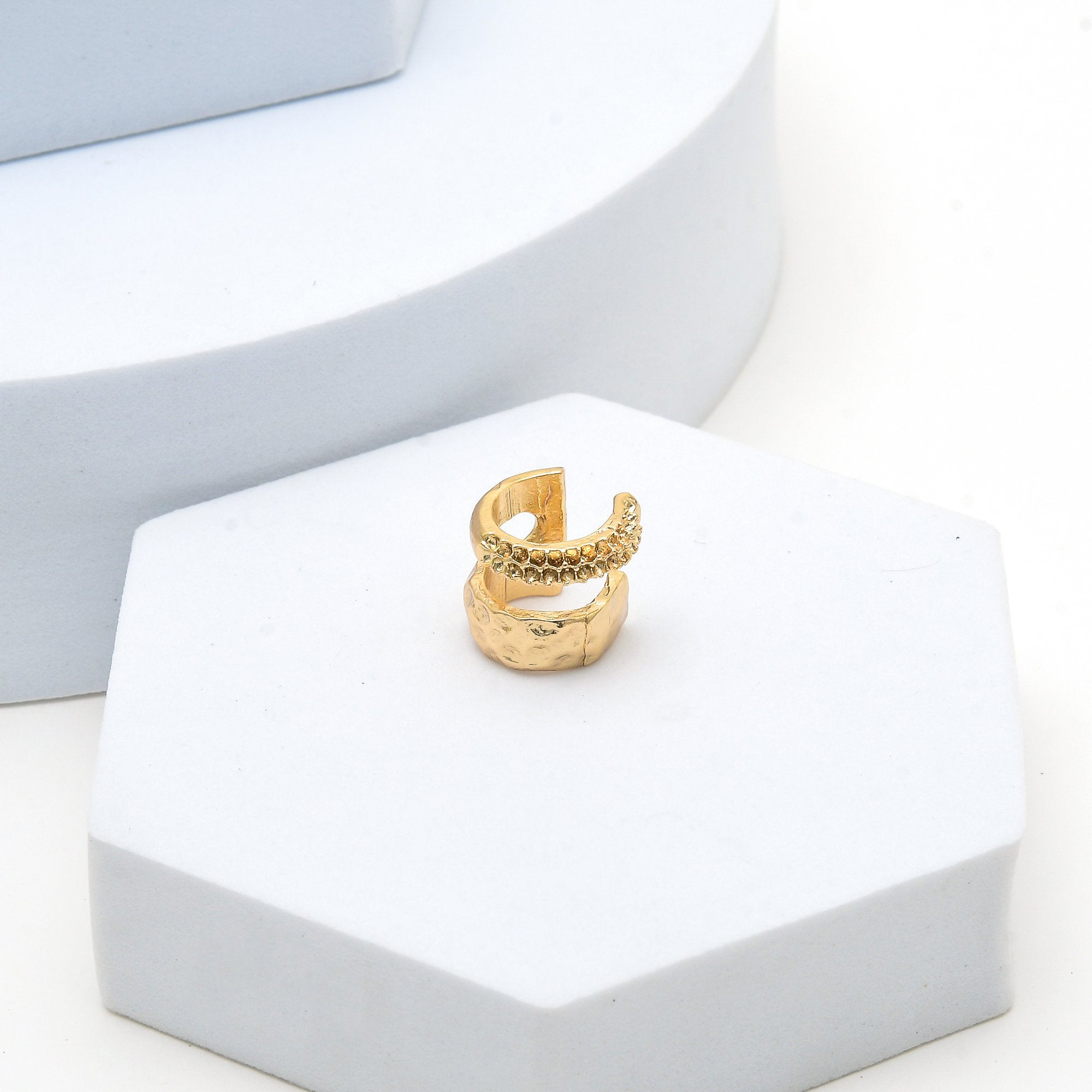 Minimal gold brass ear cuff featuring textured hammered finish by Civaro