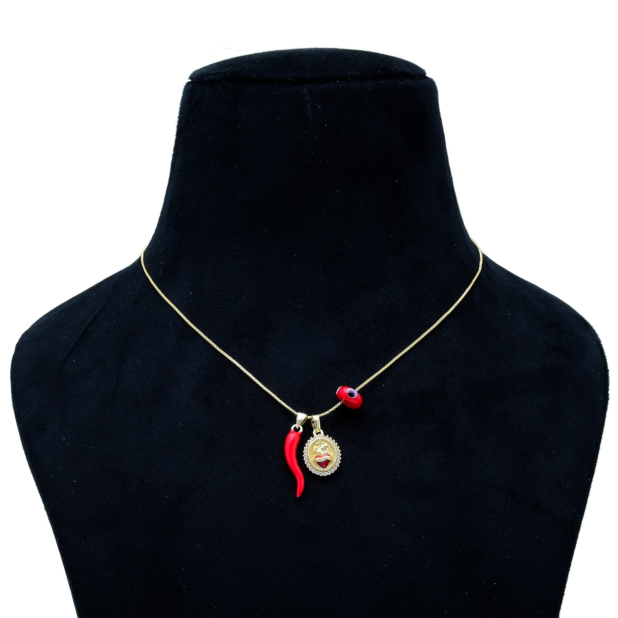 A gold chain necklace with a pendant featuring a red chili pepper and a small circular emblem, displayed on a black velvet jewelry bust against a white background. Protection charm necklace with evil eye bead in gold by Civaro