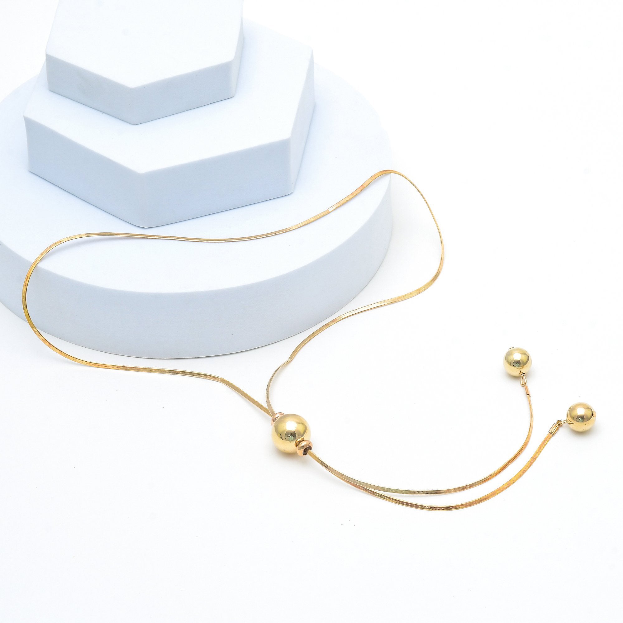 Elegant metallic statement necklace for women with long drop pendant.