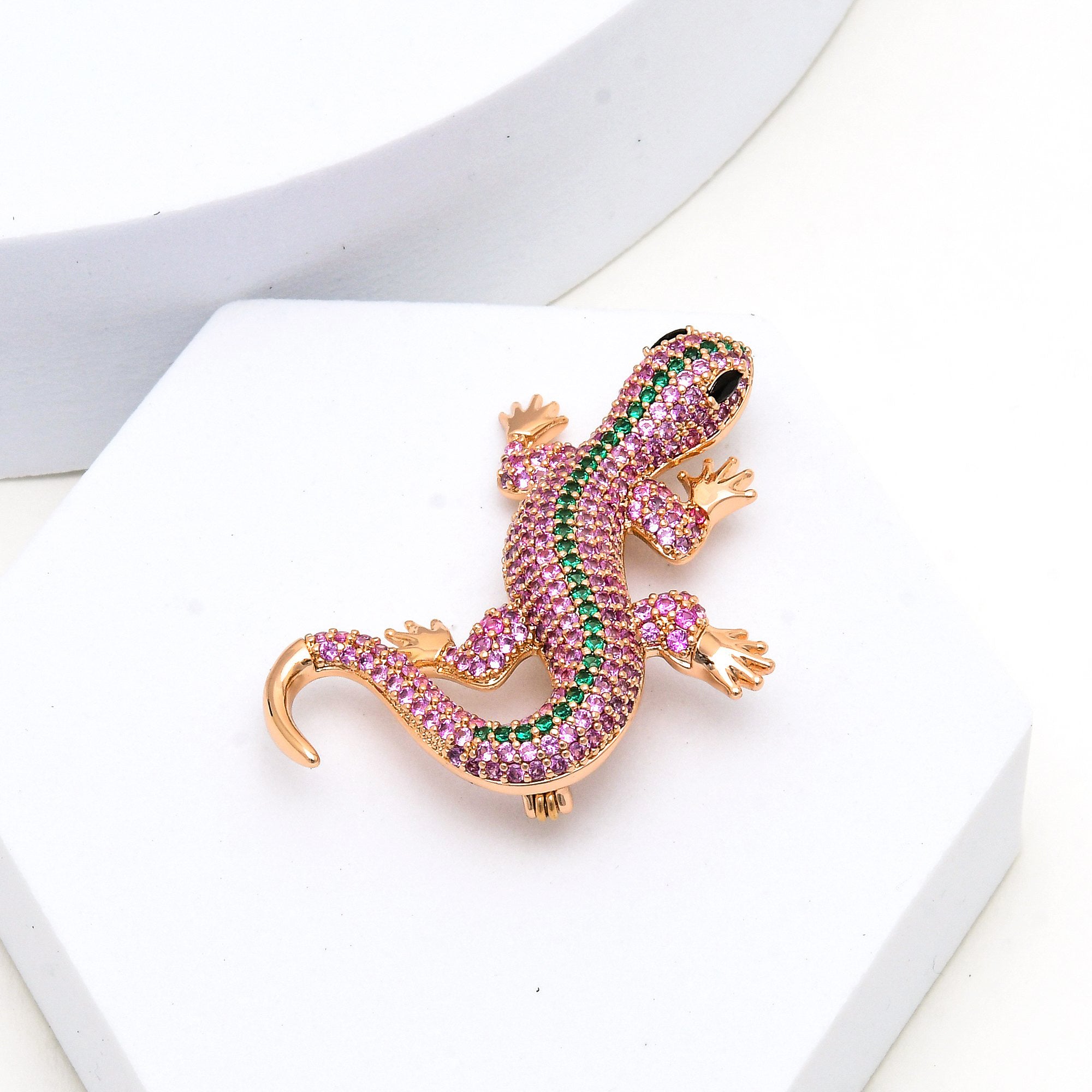     Luxury gecko lapel pin featuring sparkling pink cubic zirconia and anti tarnish stainless steel.
