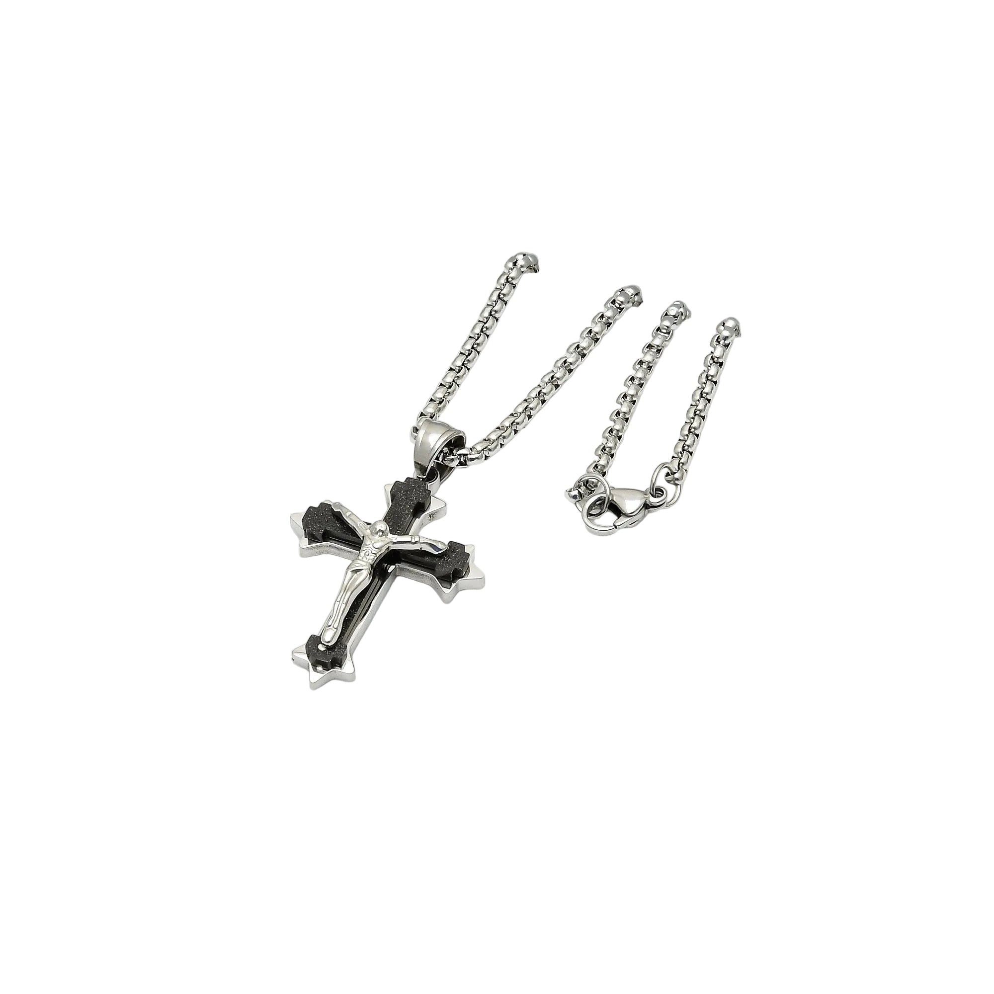 Silver cross pendant necklace on a white hexagonal stand with a white background
