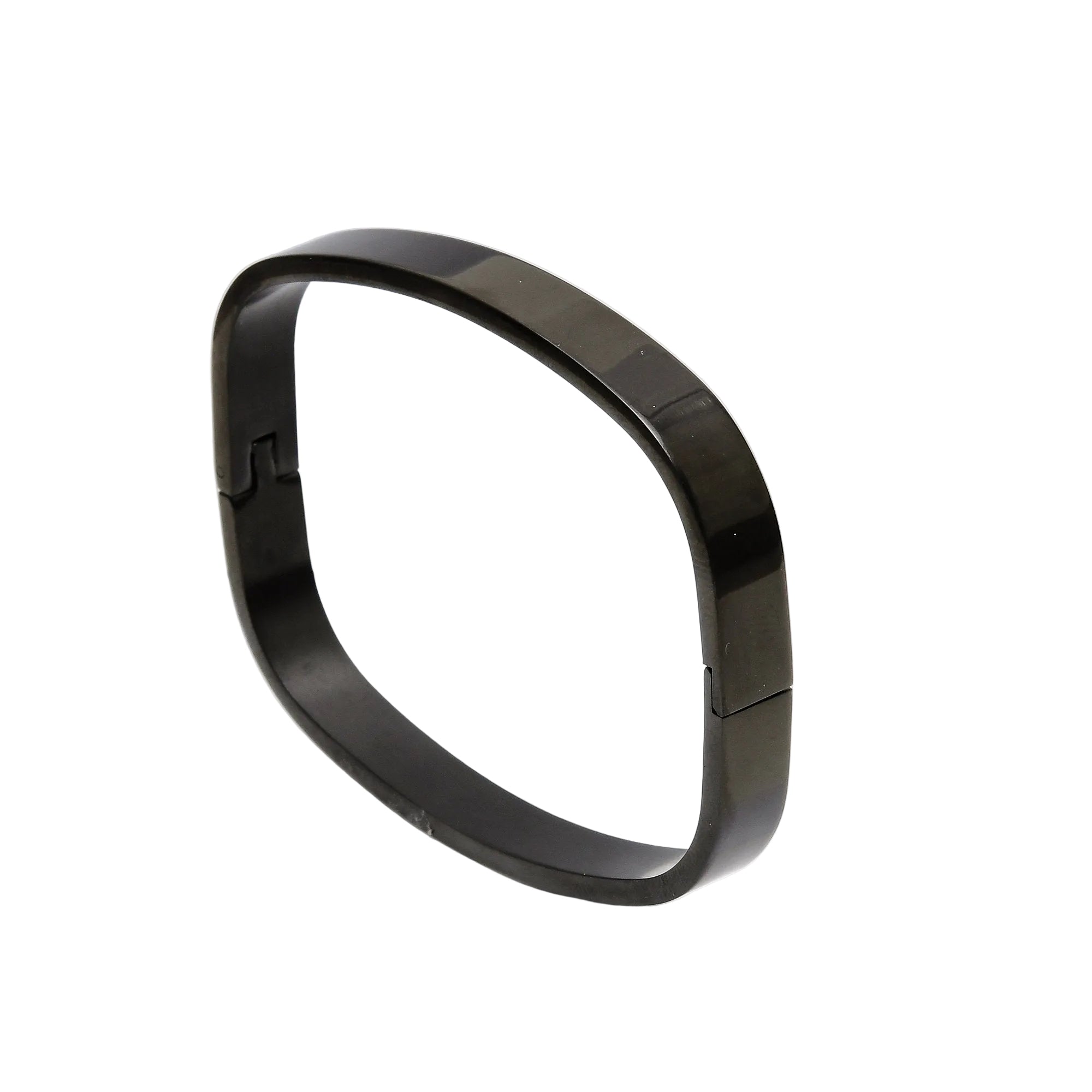 Black bracelet on a white surface with a light gray background