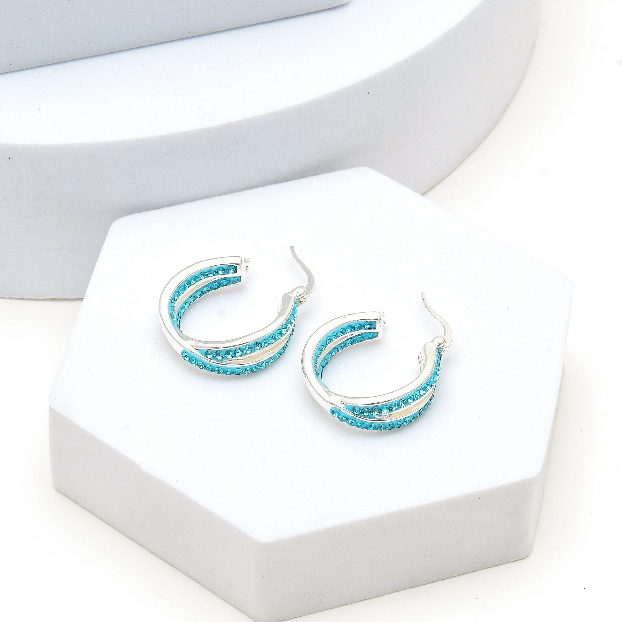 Pair of premium silver plated blue crystal dual-row statement hoops displayed on a minimalist background