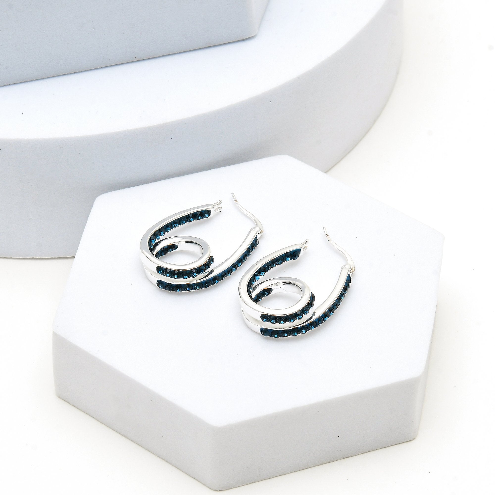 Silver tone double hoop earrings with blue crystal detailing