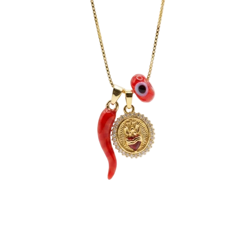 A gold-tone necklace featuring a dangling charm with a red chili pepper, a round gold medallion, and a small red evil eye bead, shown against a plain white background.
Sacred heart red chili charm necklace in 18K gold plated brass by Civaro