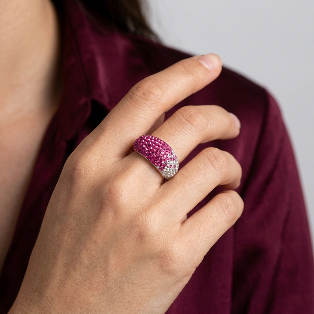 Hand wearing the handcrafted Signature Fuchsia Ombré Dome ring to showcase its substantial weight and vibrant, light-catching color depth