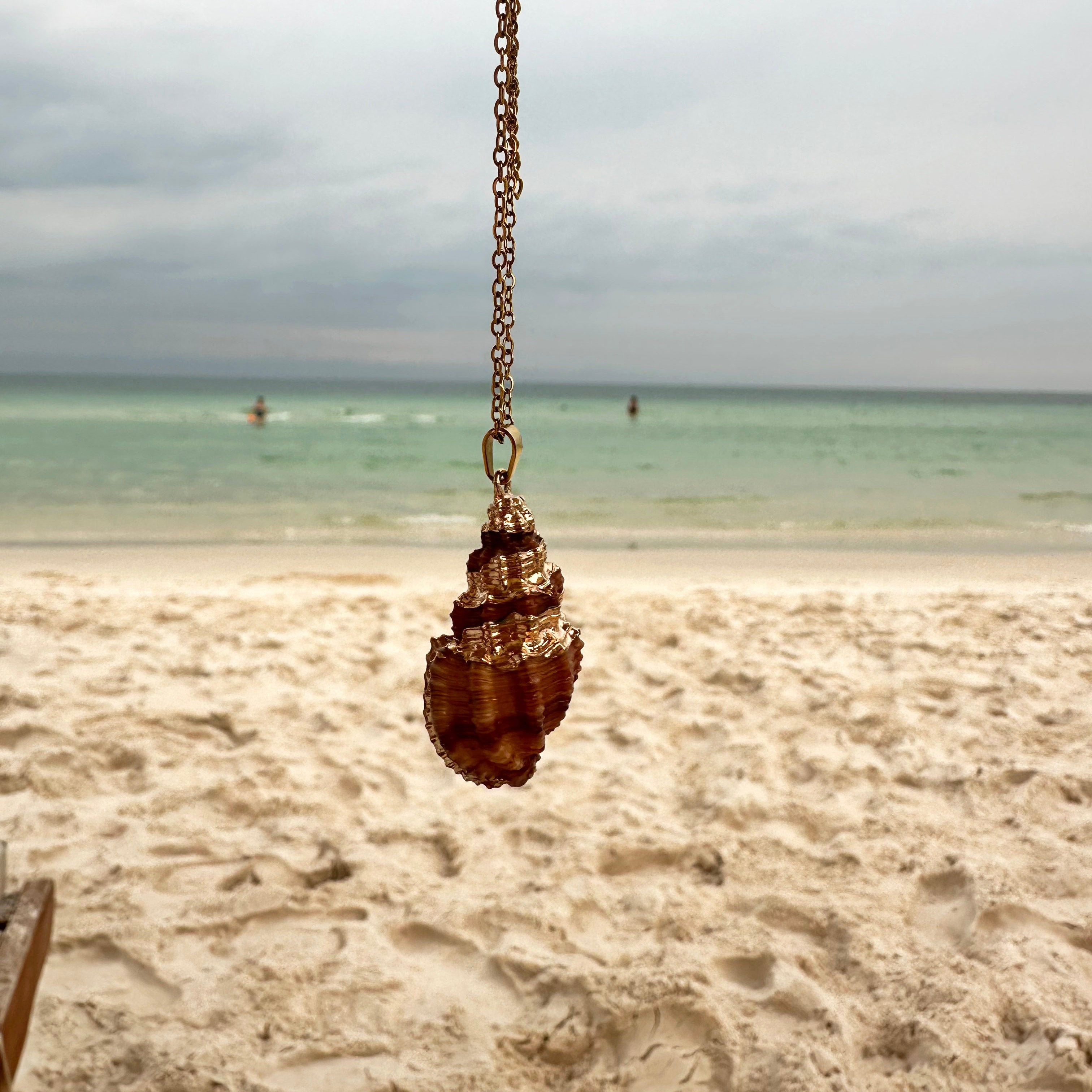 Coastal-inspired shell pendant necklace with gold detailing